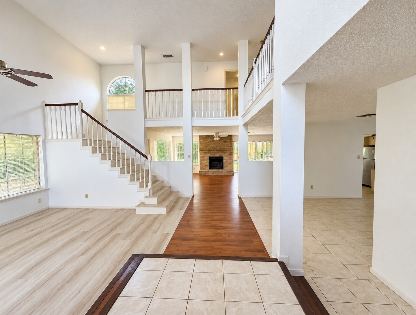 Open entryway featuring soaring ceilings and a beautiful staircase.