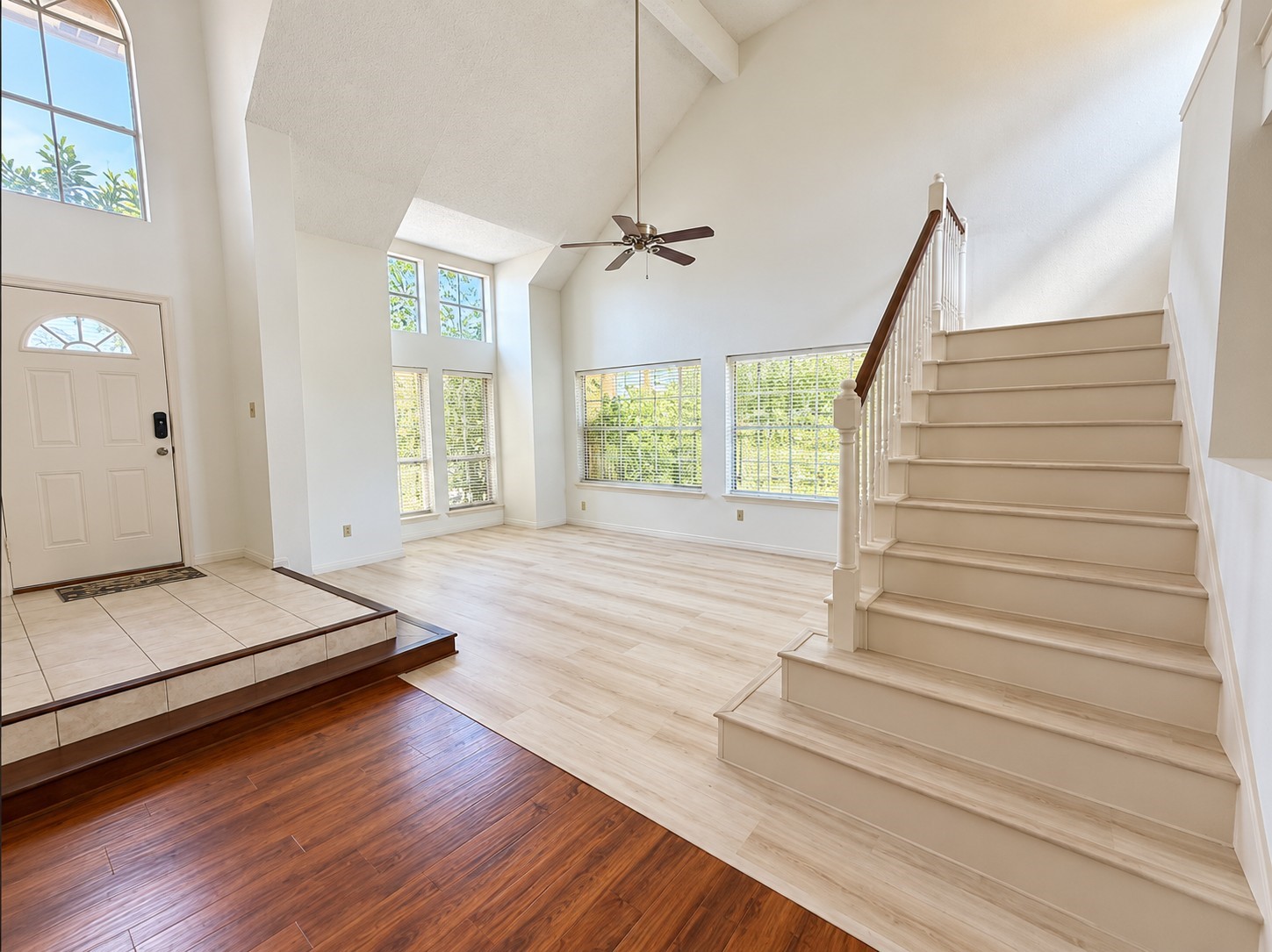 Welcoming foyer with high ceilings and staircase leading to the second floor.