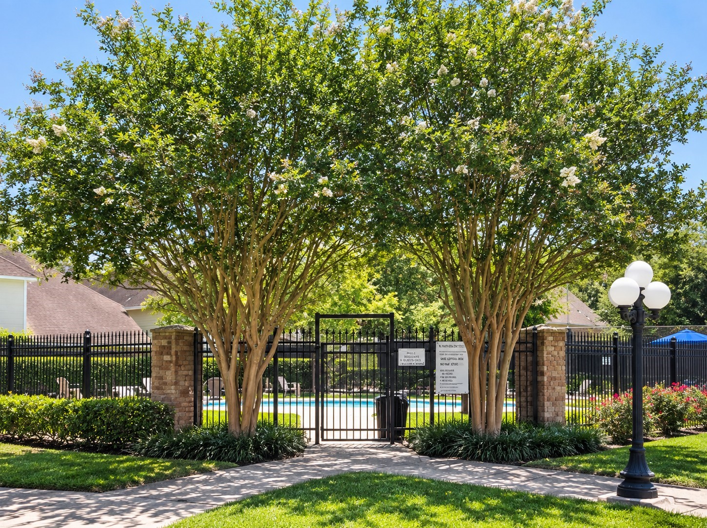 Beautifully landscaped community center space with mature shade trees.