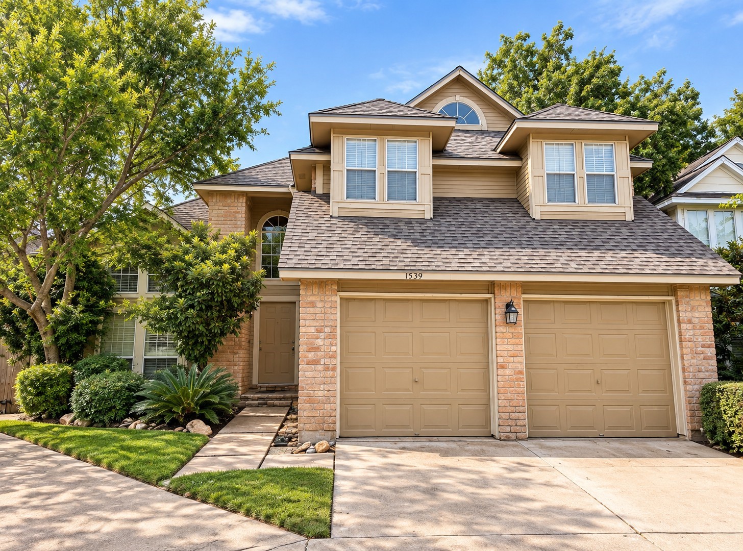 Charming two-story home with a two-car garage and mature landscaping. Charming two-story home with a two-car garage and mature landscaping.