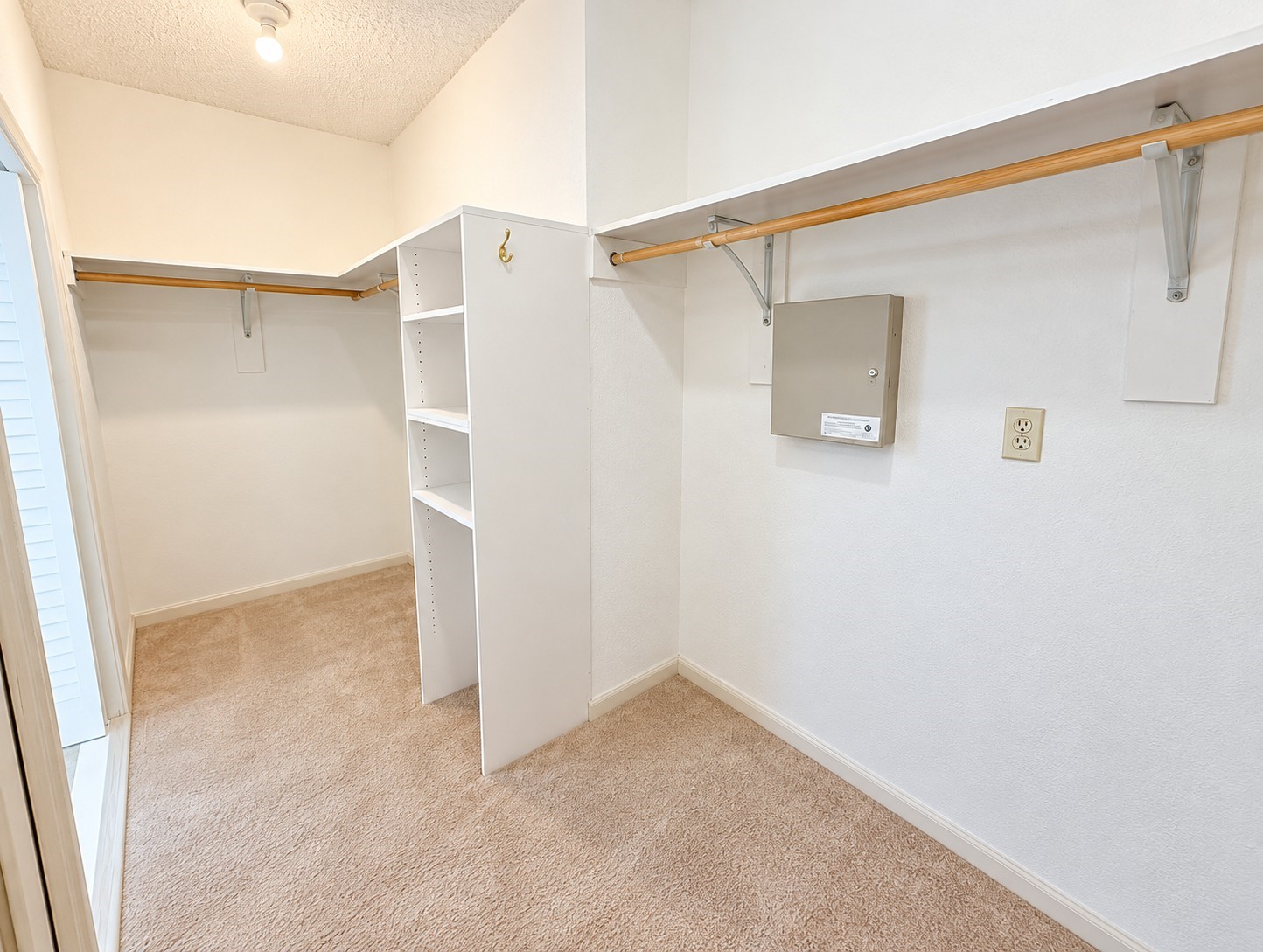 Spacious walk-in closet with built-in shelving and hanging space.