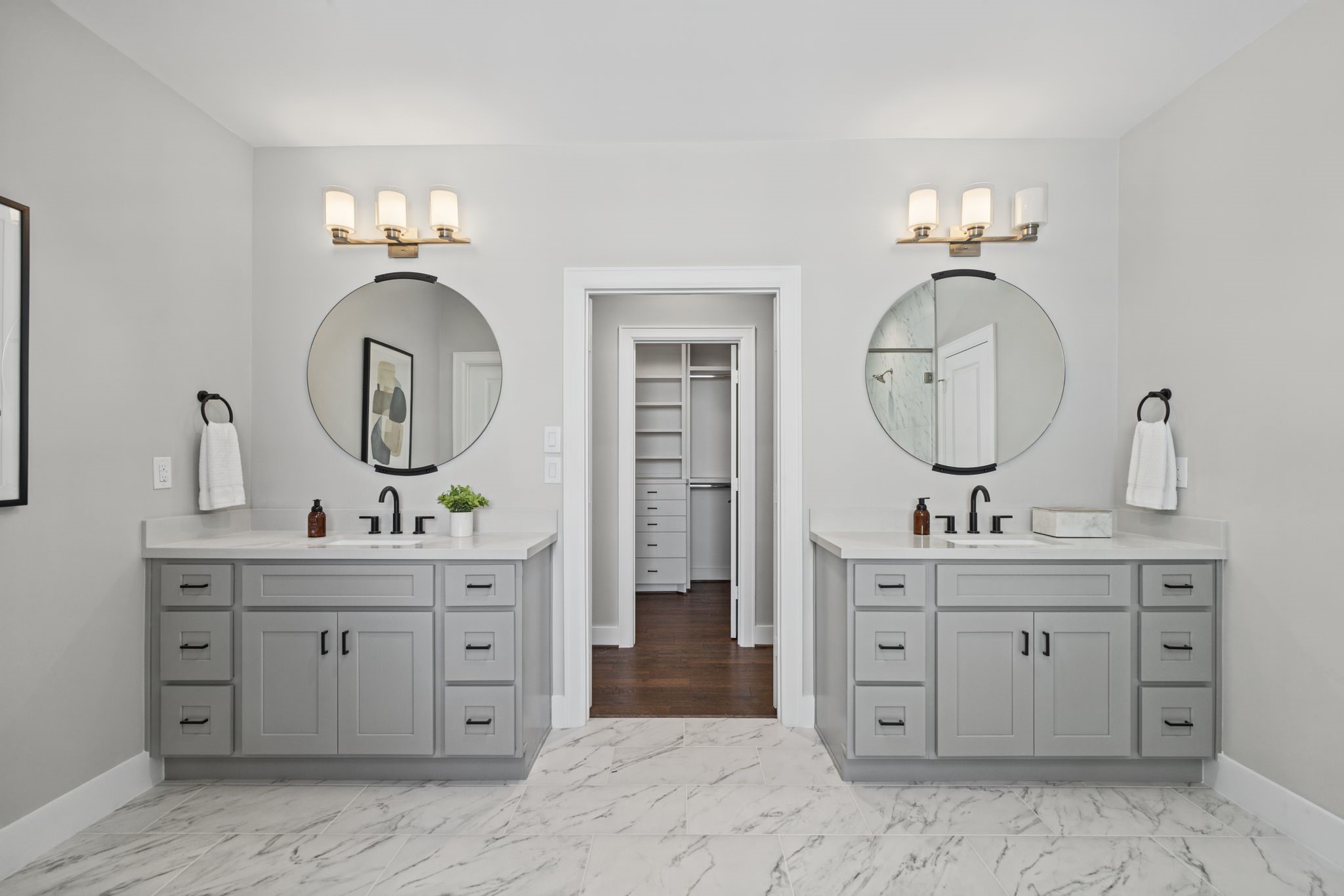 Dual vanities, contemporary fixtures, framed mirrors, and elegant finishes deliver a polished, spa-inspired aesthetic.