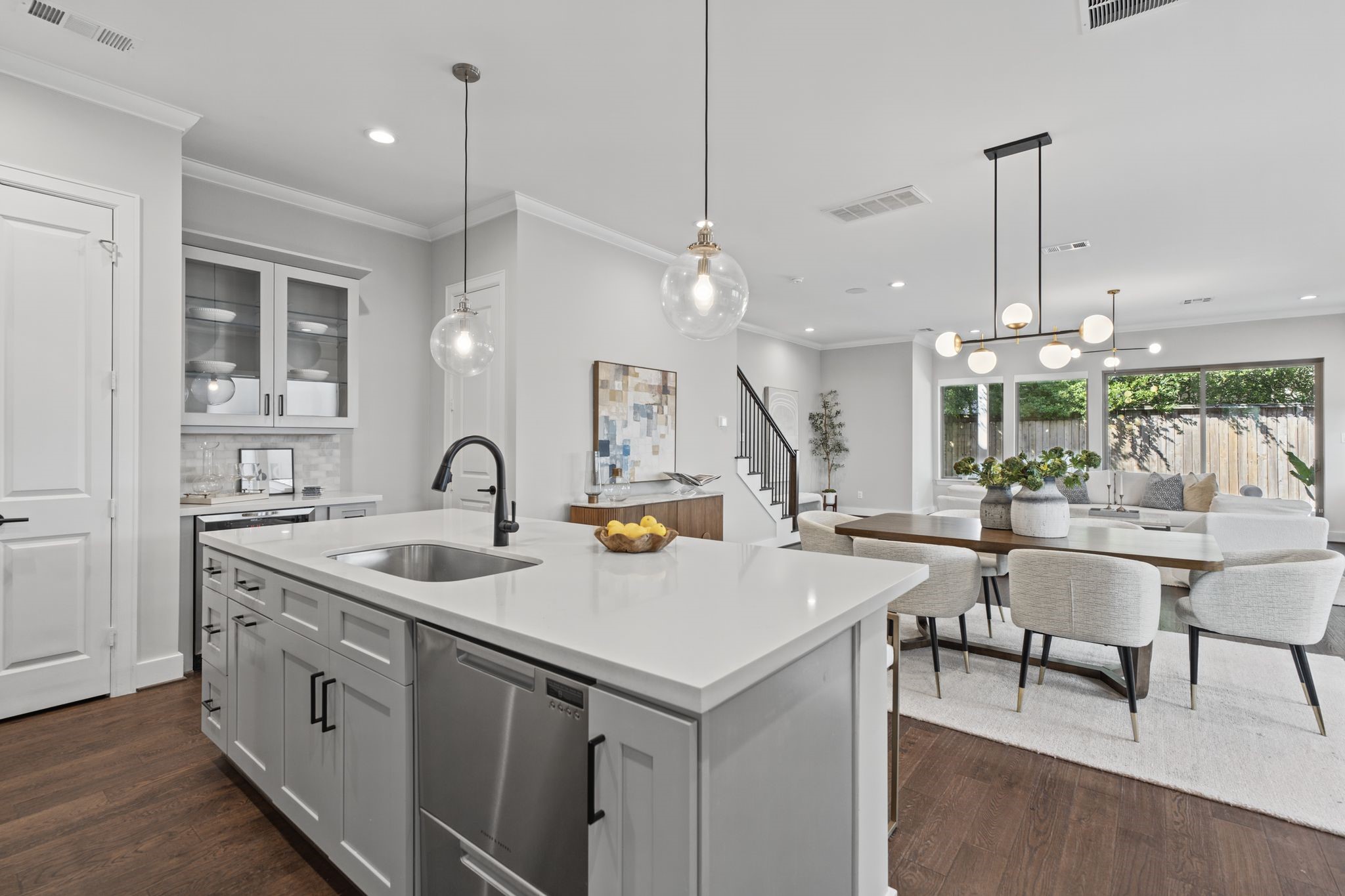 The open layout allows the kitchen to flow effortlessly into the dining and living spaces, creating an inviting atmosphere for hosting and daily life.