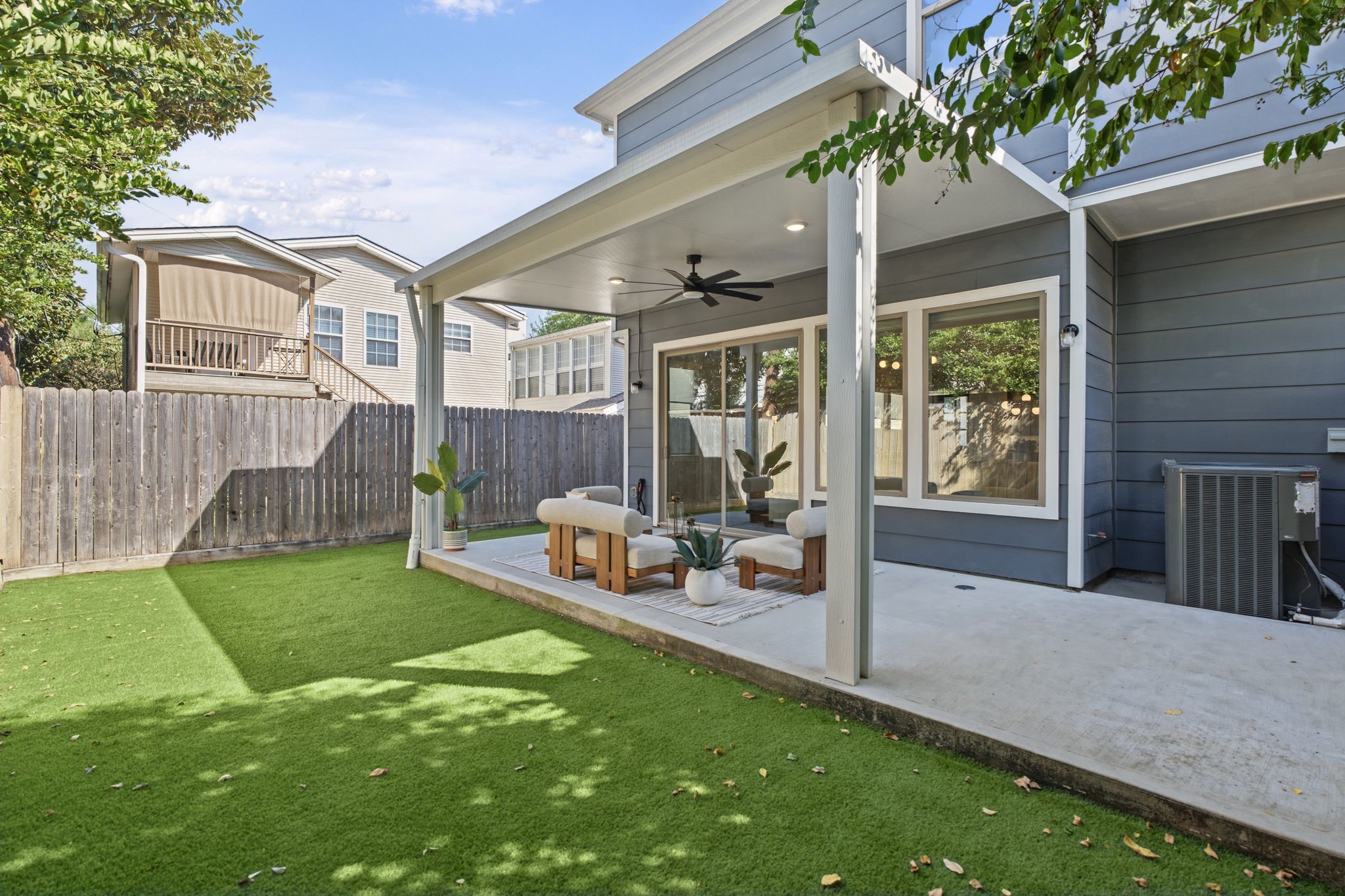 A fenced backyard with low-maintenance brand new turf offers a private outdoor setting for relaxing, entertaining, or enjoying time outside.