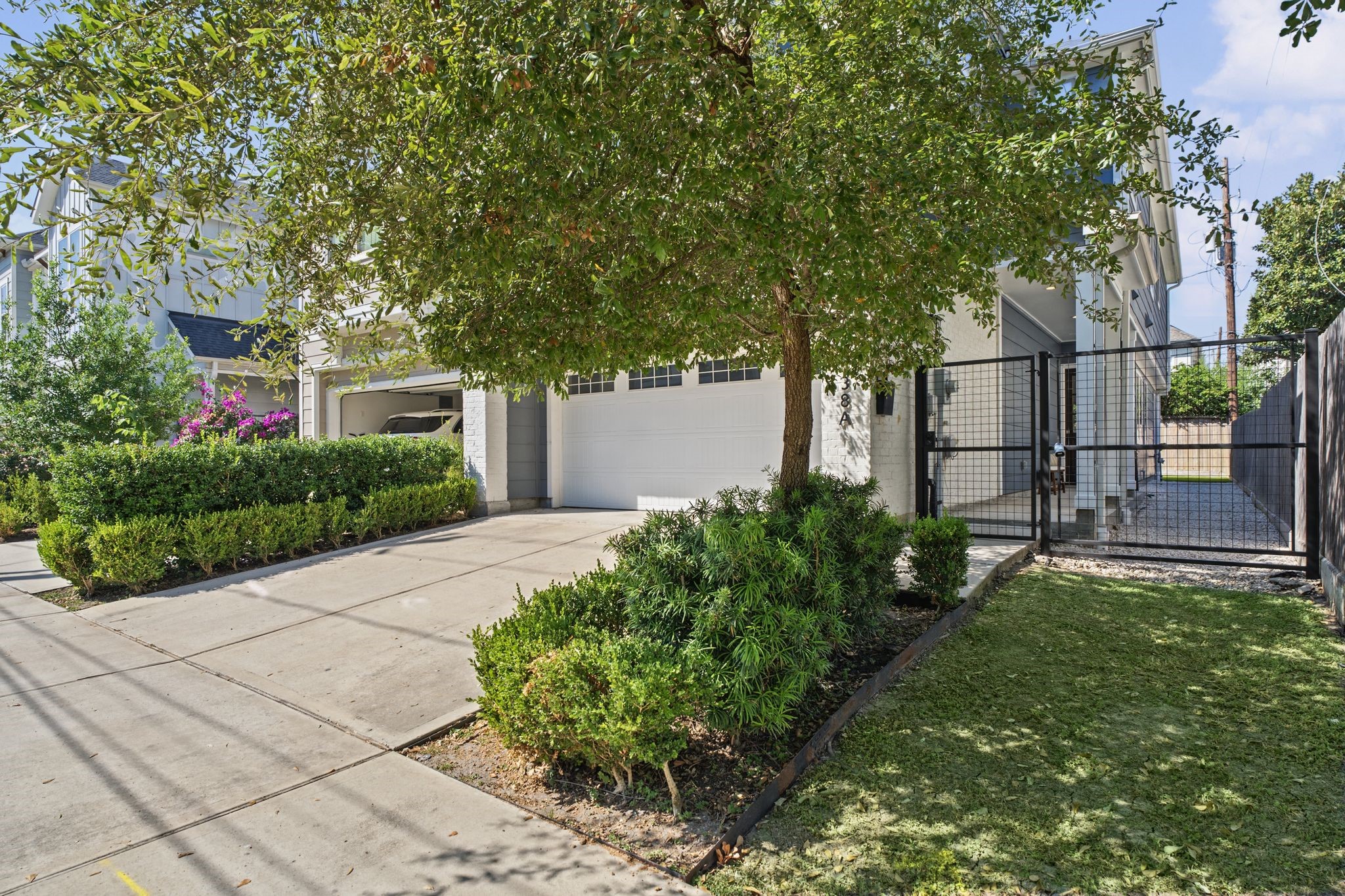 Thoughtfully landscaped grounds, mature greenery, and a generous driveway create an appealing introduction to the home.