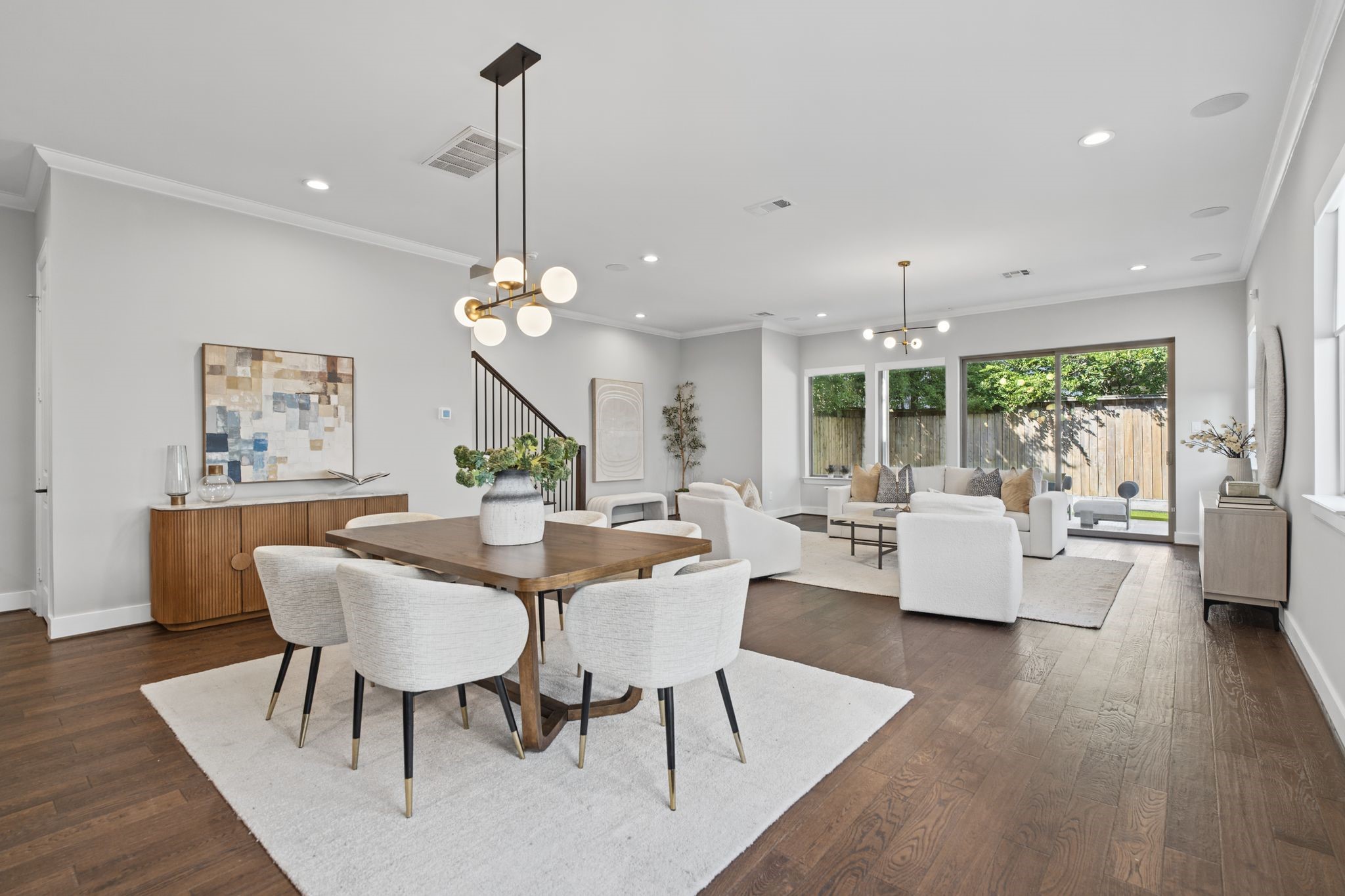 Sunlit interiors, warm wood flooring, tailored neutral finishes, and designer-inspired lighting create an elegant, cohesive setting for everyday living and entertaining.