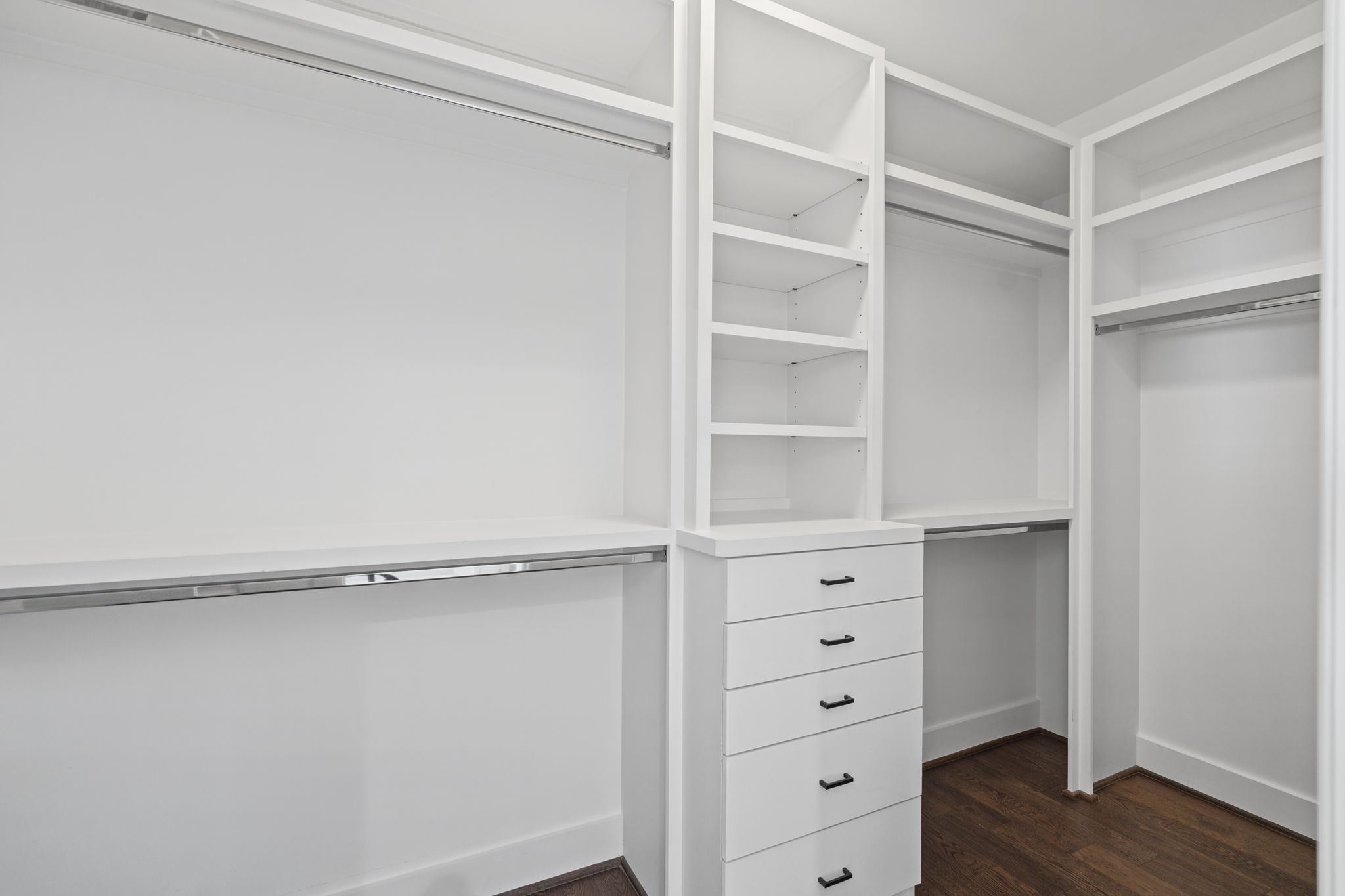 Custom-style built-in organization with generous hanging space, shelving, and drawers offers an elegant, practical solution for wardrobe storage.