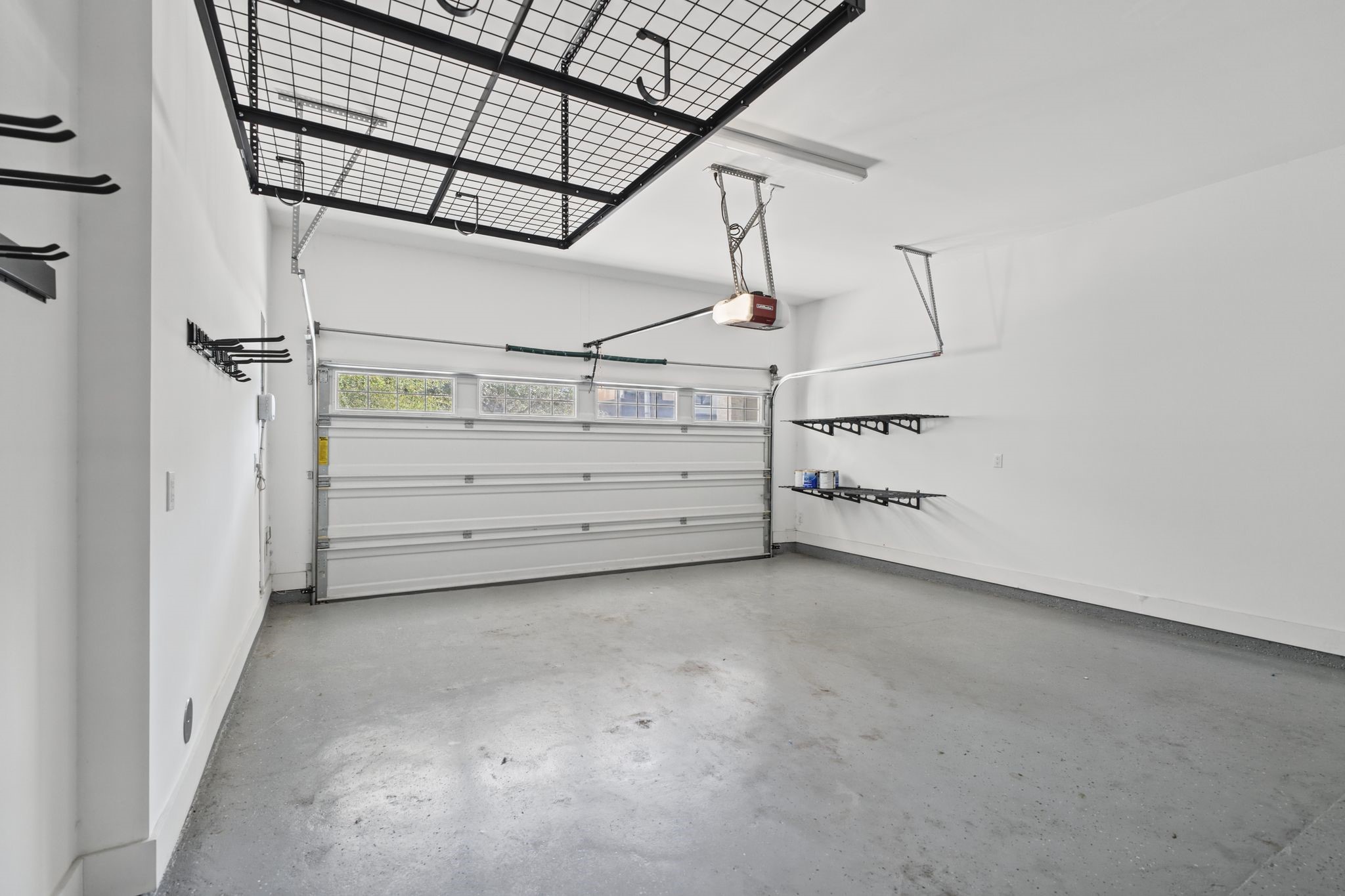 Another view of the garage space with additional storage racks.