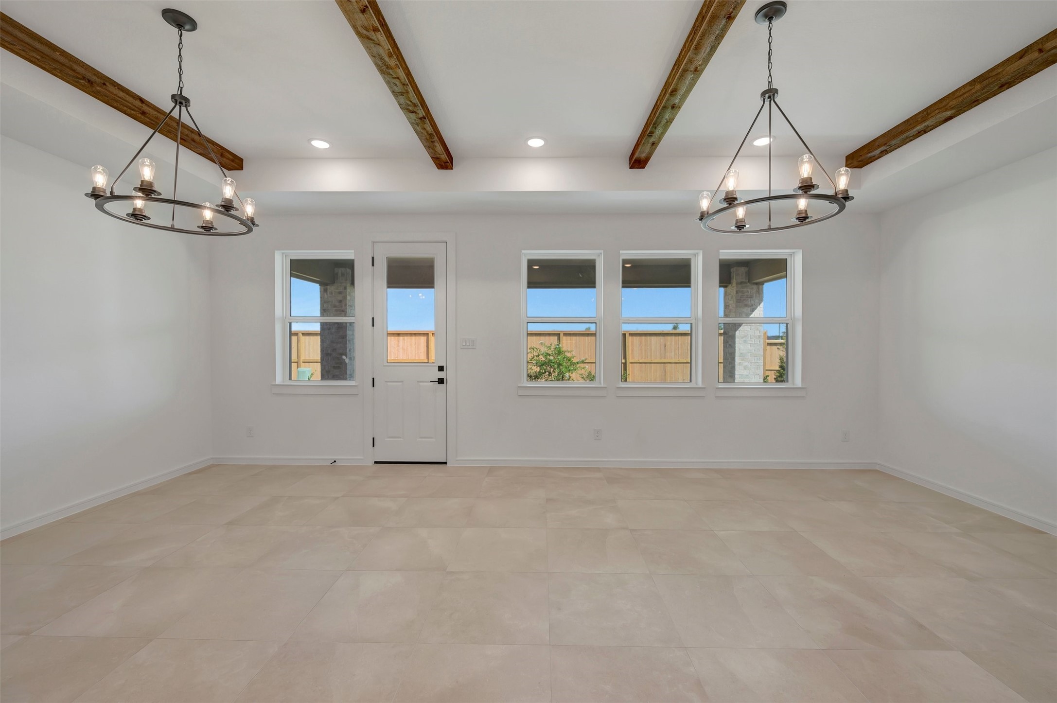 Bright and airy living area with stained ceiling beams (*Photo not of actual home and used for illustration purposes only.)