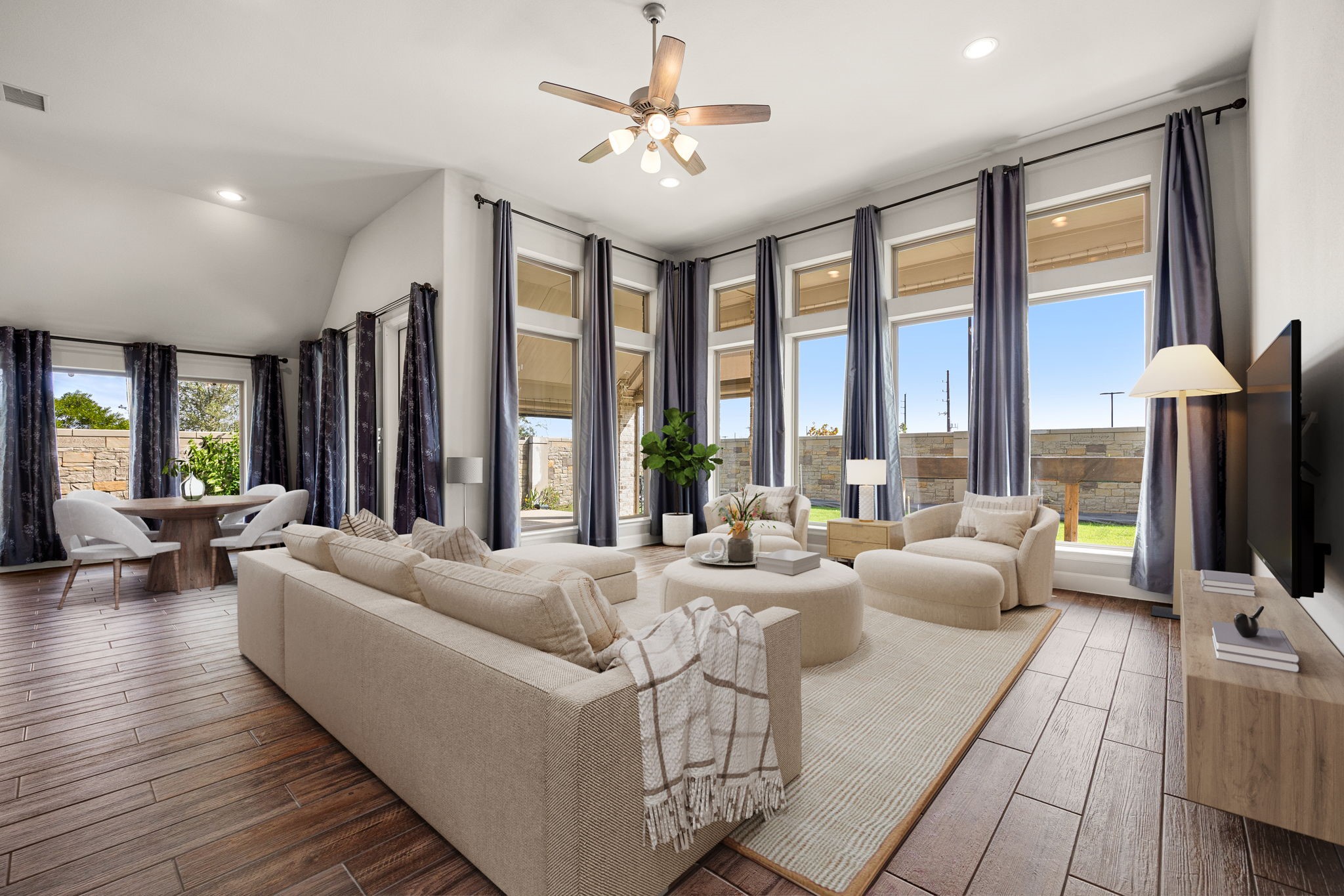 Designed with hosting in mind, this sprawling layout connects living, dining and kitchen spaces effortlessly. Whether you are gathering around the dinner table or lounging on the sofa, the continuous wood-look tile floors and sheer abundance of natural light create an environment that feels both grand and incredibly cozy. *Virtually Staged