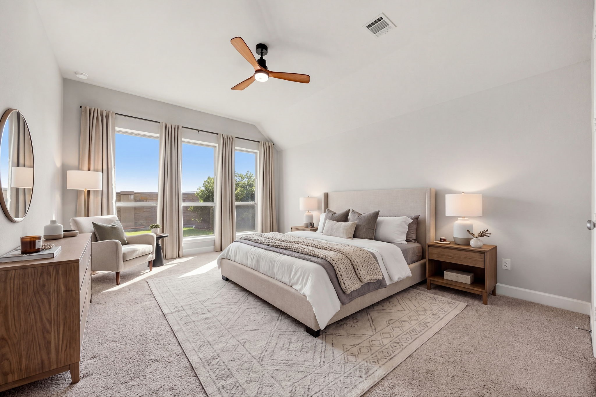 Unwind in a true retreat designed for rest and relaxation. The primary bedroom's soaring sloped ceilings create an incredibly open, airy feel, while the neutral color palette, plush carpeting, and abundance of natural light provide a warm, peaceful space to escape to at the end of the day. *Virtually Staged