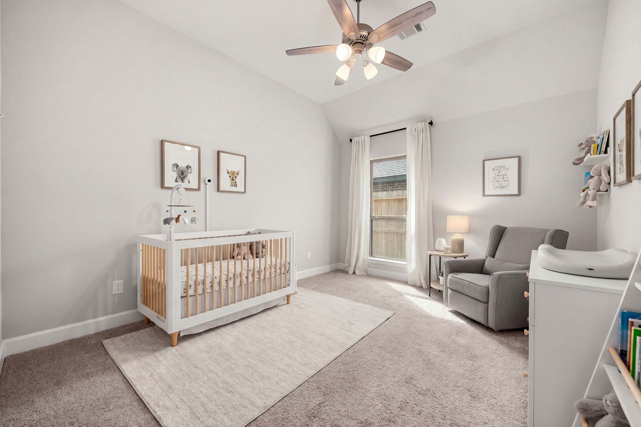 This spacious third secondary bedroom functions beautifully as a private guest suite or nursery. It boasts high sloped ceilings, plush carpeting, a multi-light ceiling fan, and the ultimate convenience of a private en-suite bathroom, offering visitors or family members a comfortable and independent space to unwind.