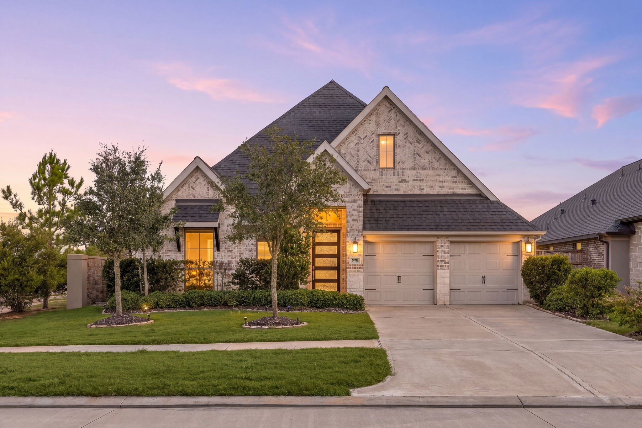 Welcome home to 29730 Smoky Ridge Road, nestled on a quiet corner lot in Creek Rush at Cross Creek Ranch and zoned to Katy ISD! This beautiful home showcases exceptional curb appeal with a manicured lawn, professional landscaping, elegant stone and brick elevation, and striking front door with glass accents. A covered front porch, charming lantern-style lighting, and a spacious double-wide driveway complete the home's timeless appeal.