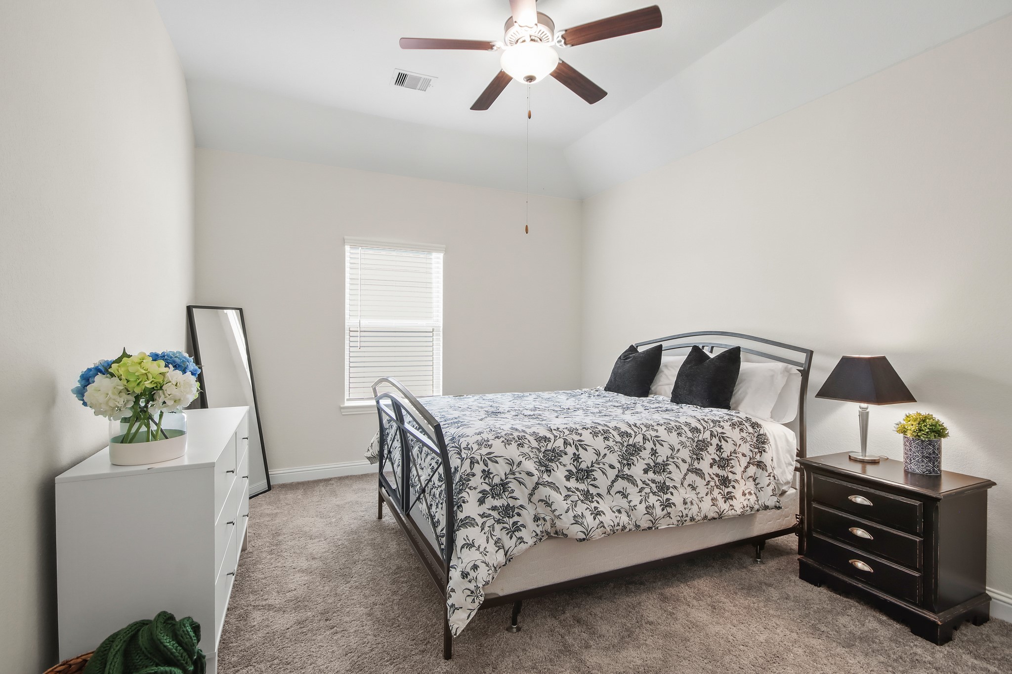 Another secondary bedroom upstairs with neutral carpet, ceiling fan and window for natural light.