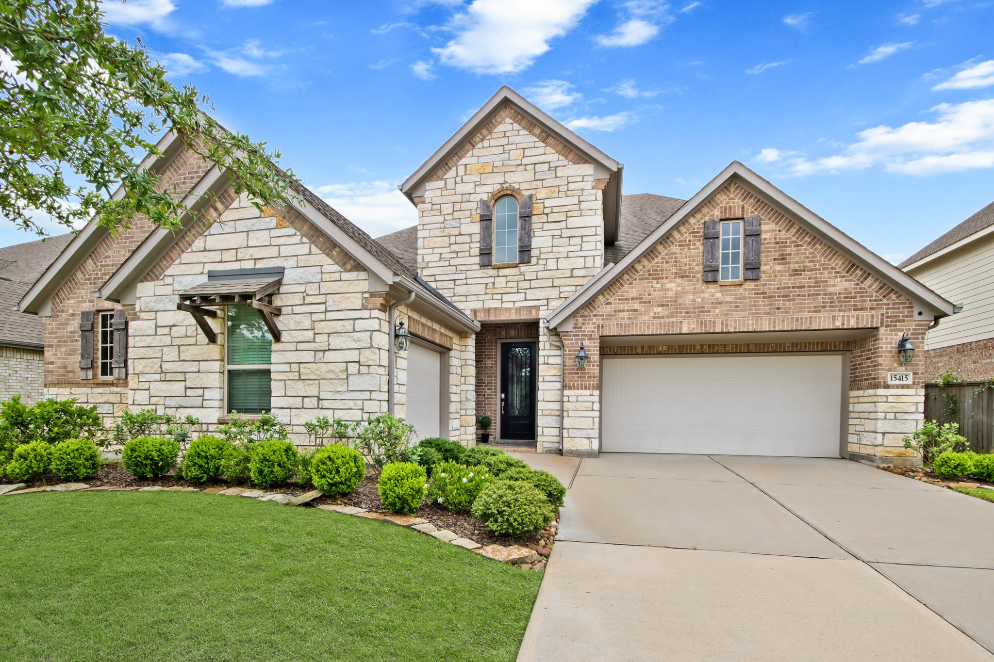 Desirable Acadia Next Gen floor plan with brick and stone elevation.