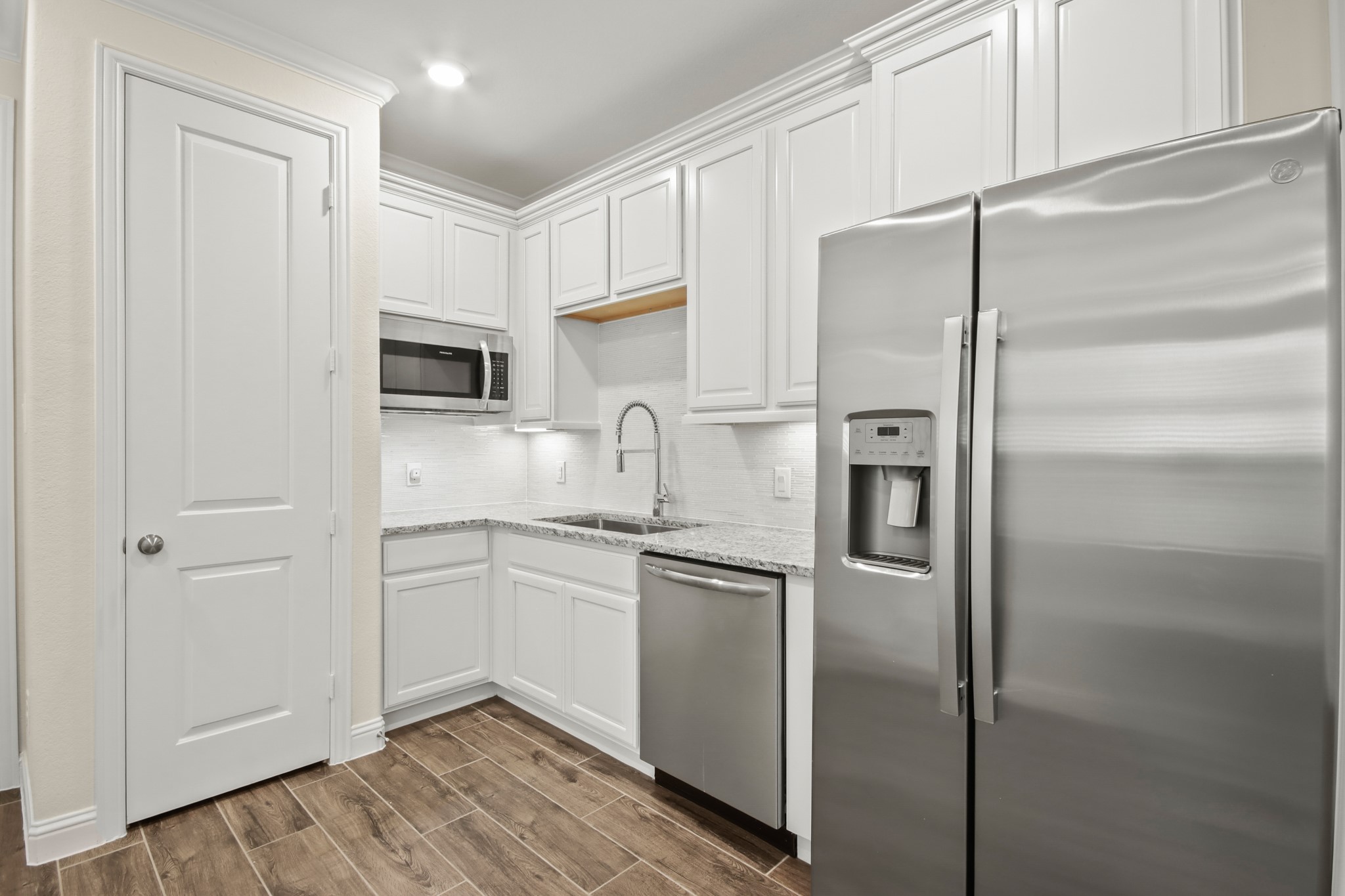 Next Gen with full kitchen, upgrade cabinets, wood tile flooring in living area.