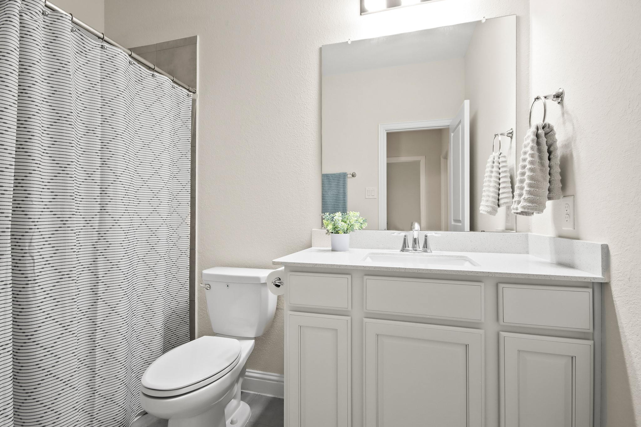 Second full bathroom upstairs with upgraded cabinets, vanity mirror and shower/bath combo.