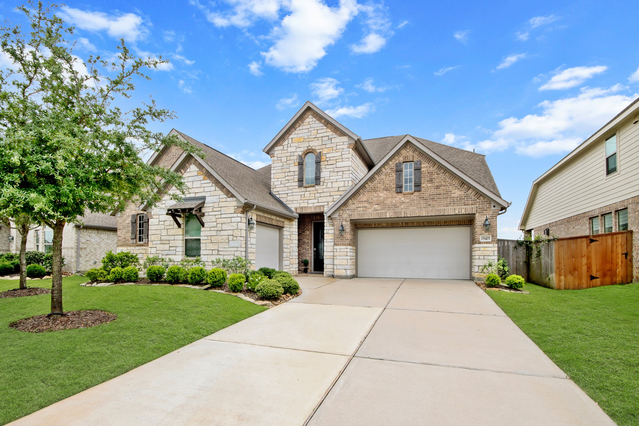 Double wide driveway leading to three car tandem garage