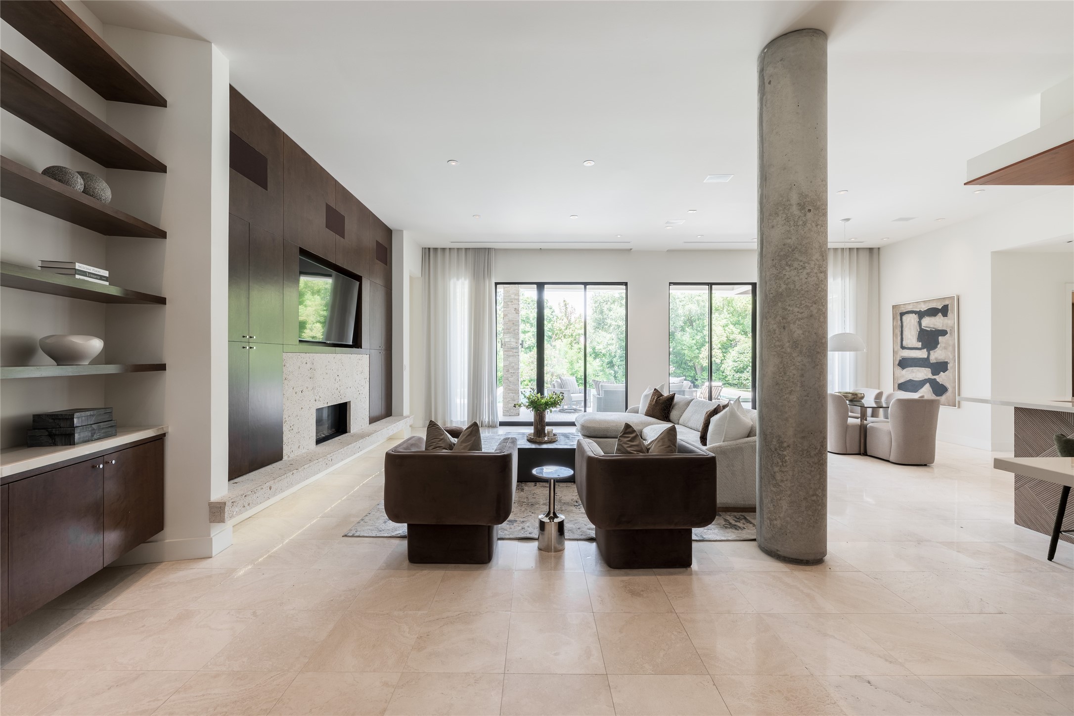 This angle reveals another perspective of the living room while extending the sightline into the covered outdoor living area. Floor-to-ceiling 10 ft sliding glass doors creates a direct visual connection between the interior living space and the outdoor entertaining areas beyond.