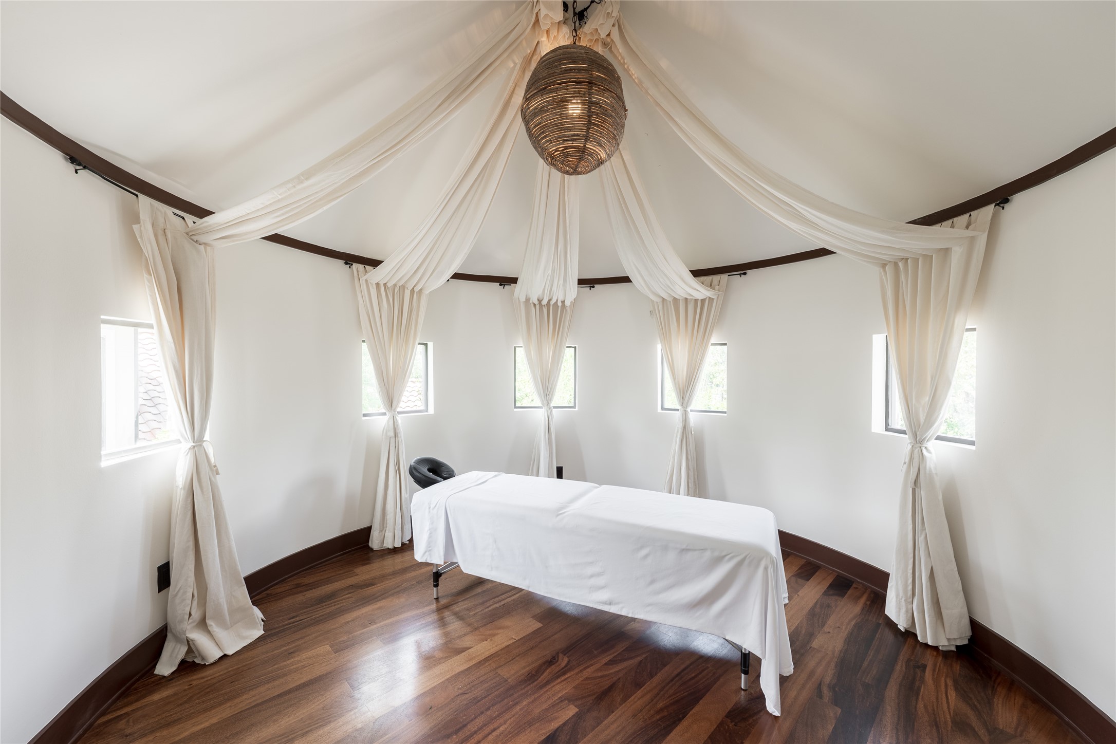 Located within a private wing on the second floor, the dedicated massage room creates a separate space for wellness and relaxation. The vaulted ceiling, wood flooring and natural light give the room an open feel while remaining removed from the homes primary living areas.