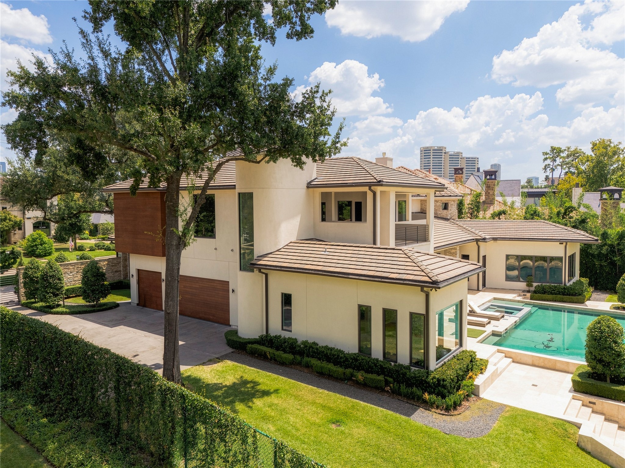 The architecture unfolds beyond the front elevation, with clean geometric forms, warm mahogany accents and mature landscaping creating a more private side of the residence. Generous setbacks allow the home to feel substantial without sacrificing openness, greenery or privacy.