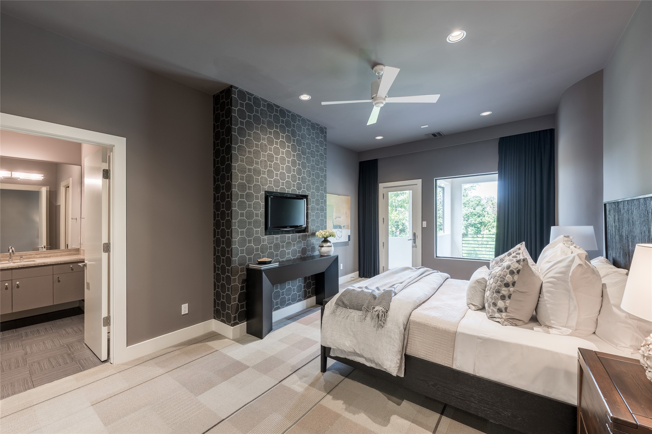A private second-floor guest suite provides its own living area with direct access to the covered upstairs balcony. The separate setting gives guests a comfortable retreat while maintaining easy access to the homes secondary living and entertaining spaces.