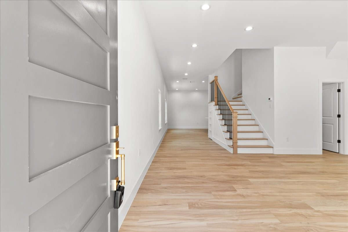 Unit A - The front units elegant entrance welcomes you home to this stunning modern duplex. Featuring a contemporary front door, clean architectural details, and beautiful curb appeal, this inviting entryway creates a warm first impression while showcasing the propertys modern design and craftsmanship.
