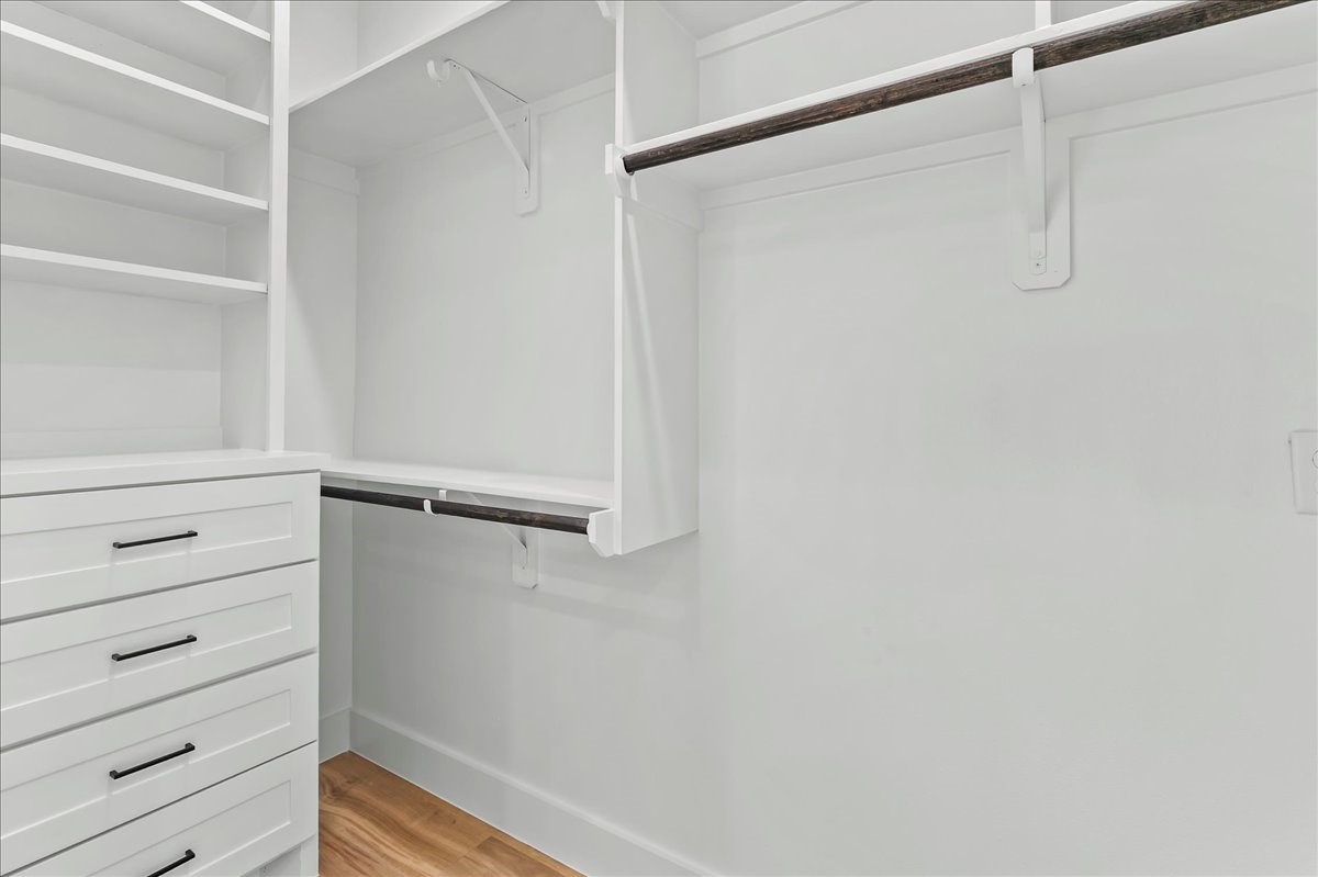 Unit B - Walk-in primary closet features custom built-in cabinetry designed to maximize storage and organization. Custom closet design may vary. Pictures are from a previous build.