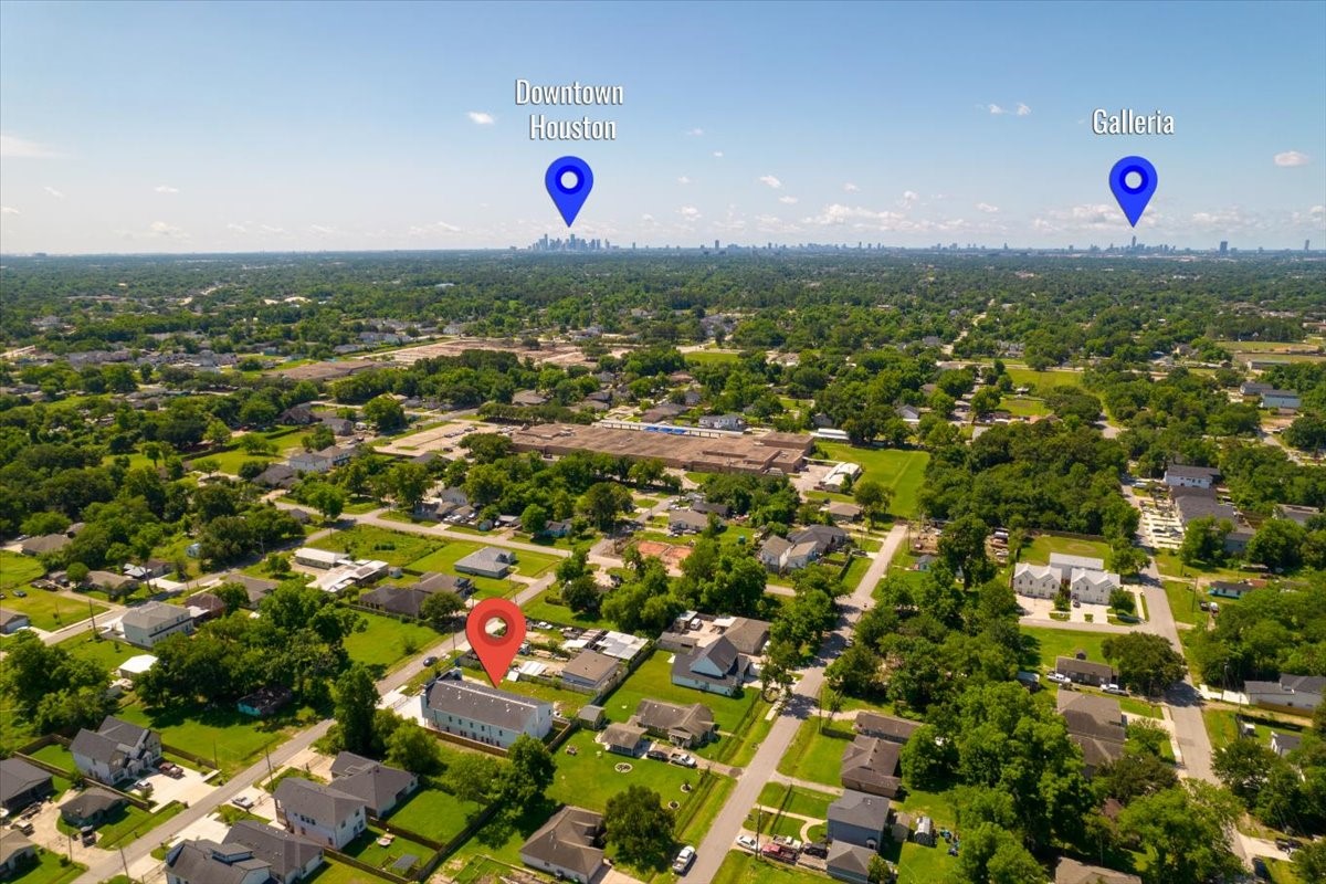 The drone perspective highlights the duplexs prime location, surrounding development, and easy access to major Houston thoroughfares.