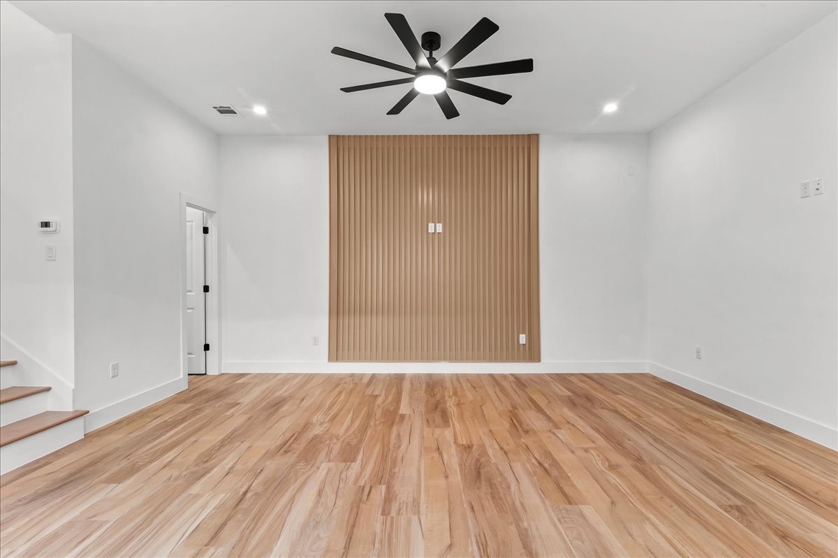 Unit B - Upon entry, youll be welcomed by a spacious living room featuring a stunning accent wall that beautifully complements the flooring, creating a warm and cohesive design. Recessed lighting and a modern ceiling fan enhance the space, providing both style and comfort while filling the room with a bright, inviting atmosphere.Accent Wall design may vary. Pictures are from a previous build.