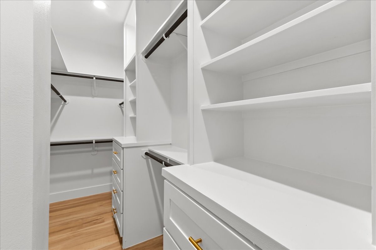 Unit A - The spacious primary closet is thoughtfully designed with custom built-in shelving and drawer chests, providing ample storage and organization while adding a luxurious, boutique-style feel to your daily routine. Custom closet design may vary. Pictures are from a previous build.