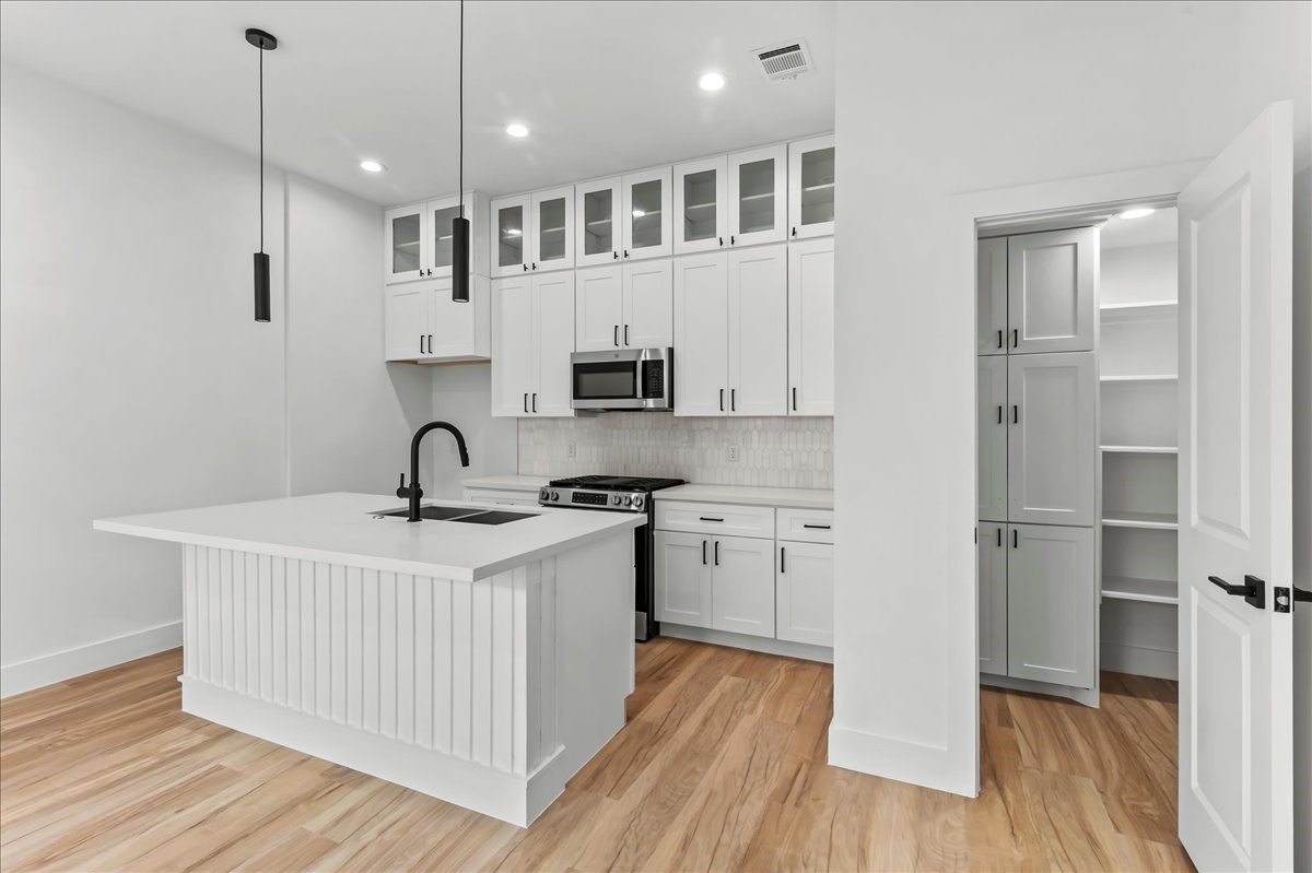 Unit B - This thoughtful layout keeps everything within reach while maintaining a clean and organized space. Accent Wall design may vary. Pictures are from a previous build.