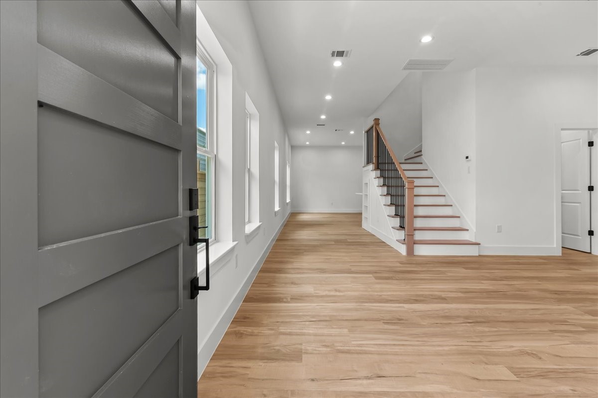 Unit B - The back units elegant entrance welcomes you home to this stunning modern duplex. Featuring a contemporary front door, clean architectural details, and beautiful curb appeal, this inviting entryway creates a warm first impression while showcasing the propertys modern design and craftsmanship.