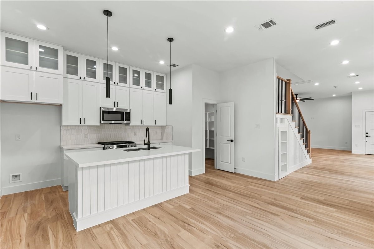 Unit B - A chefs paradise, this modern kitchen features double stacked cabinetry, stainless steel appliances, and luxurious quartz countertops. Ideal for cooking and entertaining. Design may vary. Pictures are from a previous build.