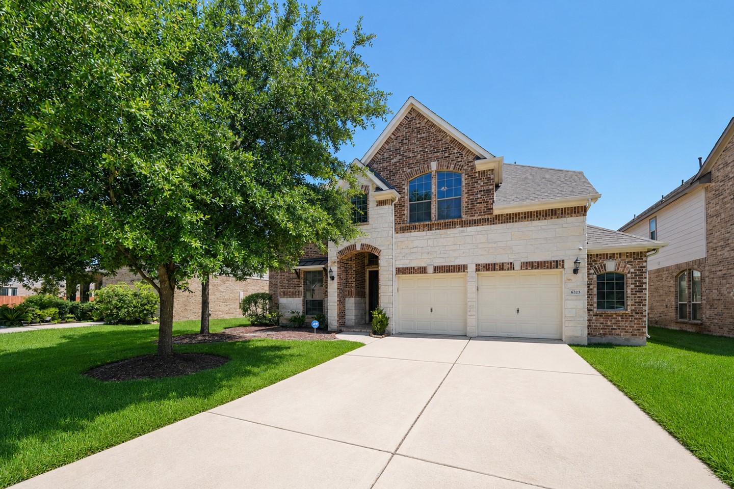 This is a charming two-story brick home with a spacious driveway and a two-car garage. It features a well-maintained front lawn with mature trees, providing ample shade. The exterior design is classic and welcoming, ideal for family living. This is a charming two-story brick home with a spacious driveway and a two-car garage. It features a well-maintained front lawn with mature trees, providing ample shade. The exterior design is classic and welcoming, ideal for family living.