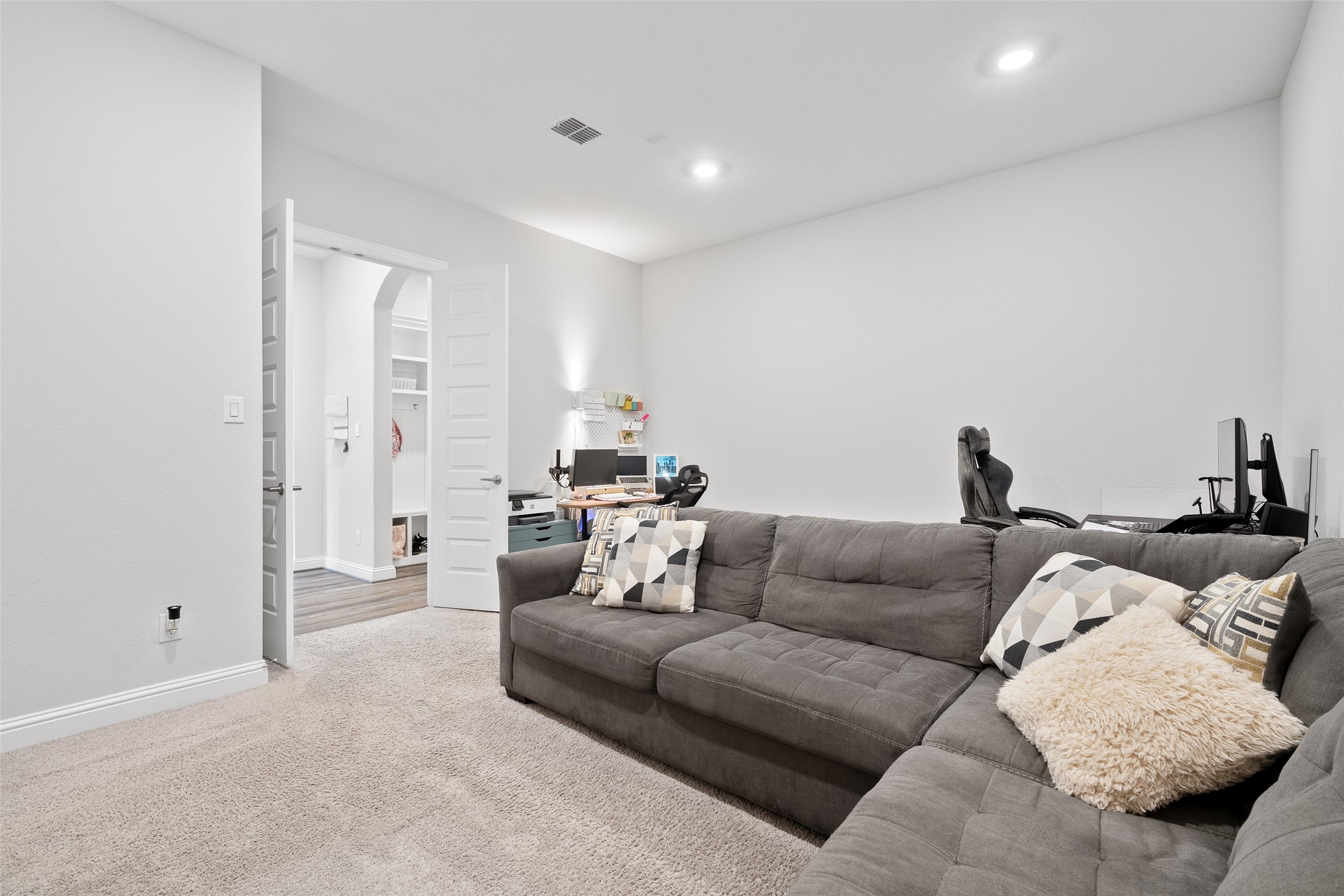 View 2 of the first-floor media room. It's the perfect open space for movie nights and entertaining, with existing wiring ready for your own customized audio and video systems.