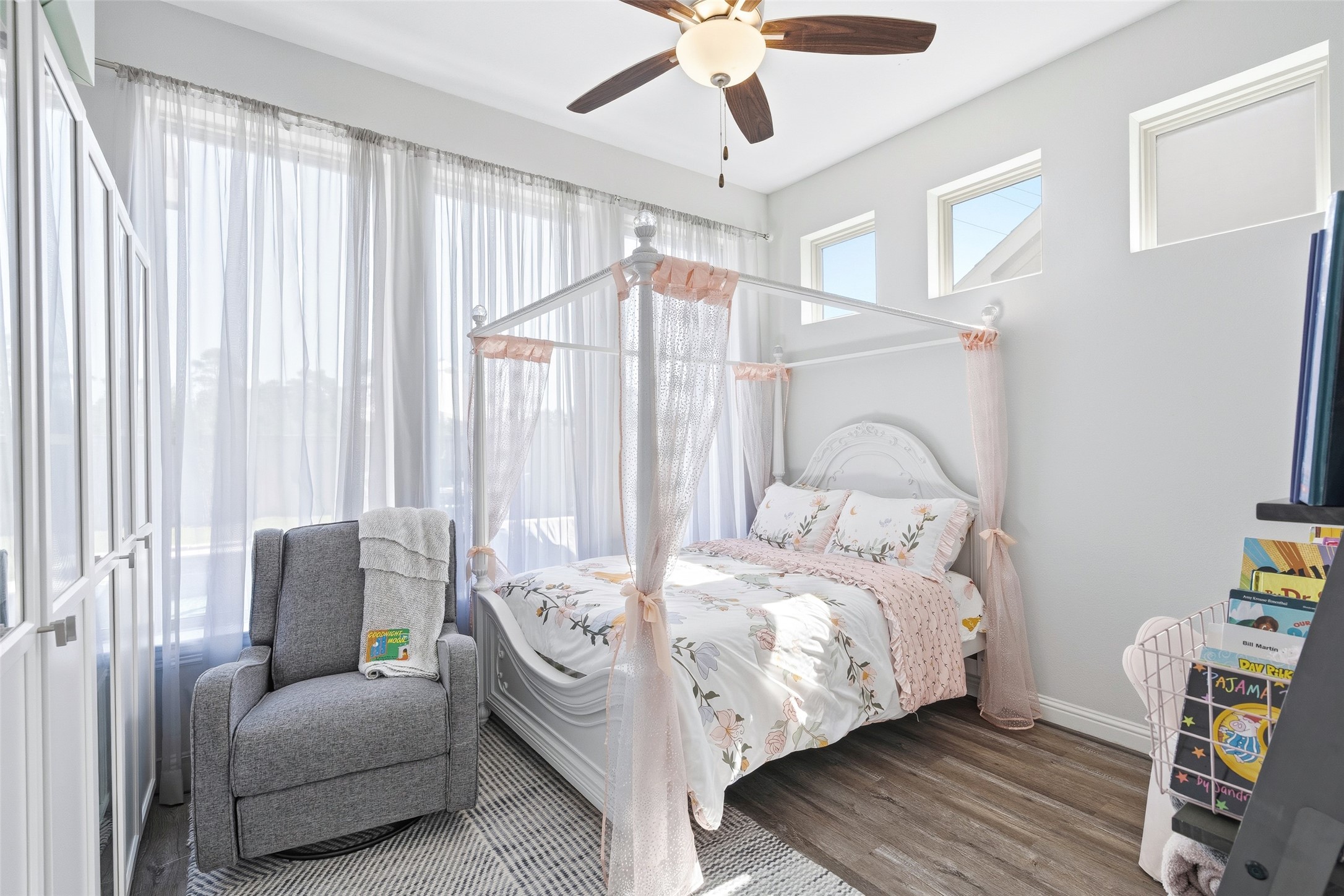 The first-floor sunroom overlooking the pool offers versatile space for a home office, flex space, or fourth living area. Currently used as a bedroom.