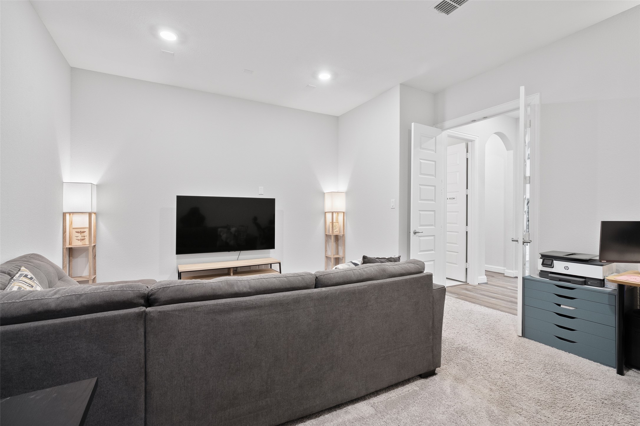 View 1 of the first-floor media room. It's the perfect open space for movie nights and entertaining, with existing wiring ready for your own customized audio and video systems.