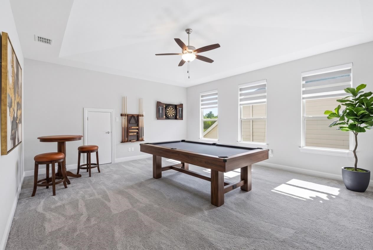 Virtual staging of this spacious second-floor game room that offers flexible living space, perfect for entertaining, a game room, or a third living area.