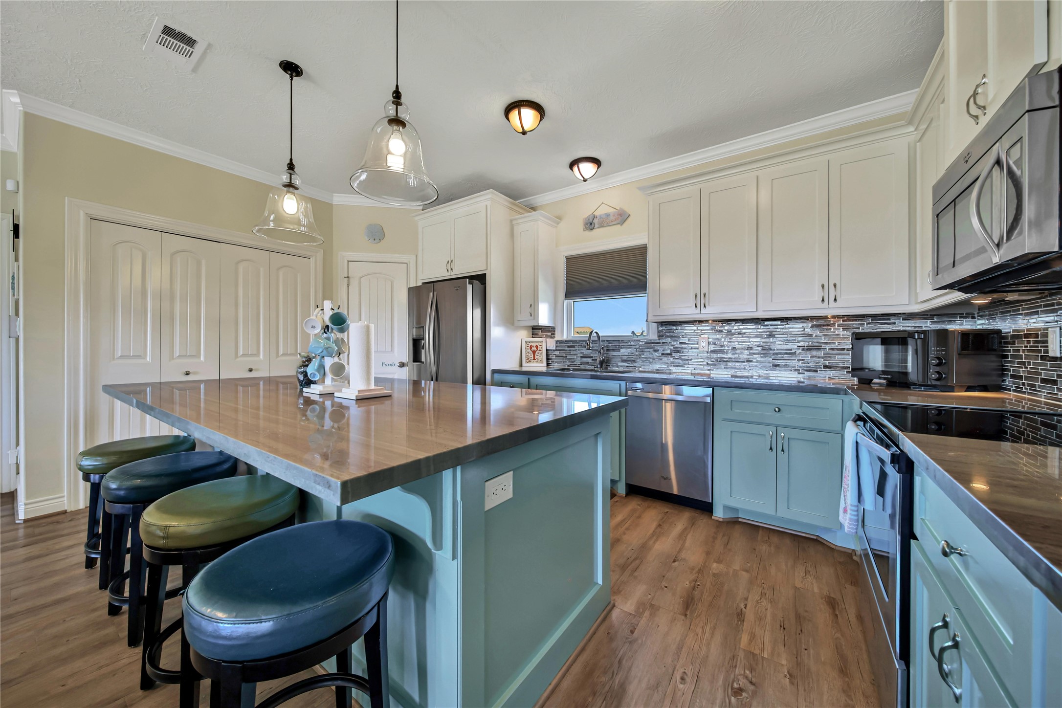 Kitchen features polished concrete countertops & modern appliances. Kitchen features polished concrete countertops & modern appliances.