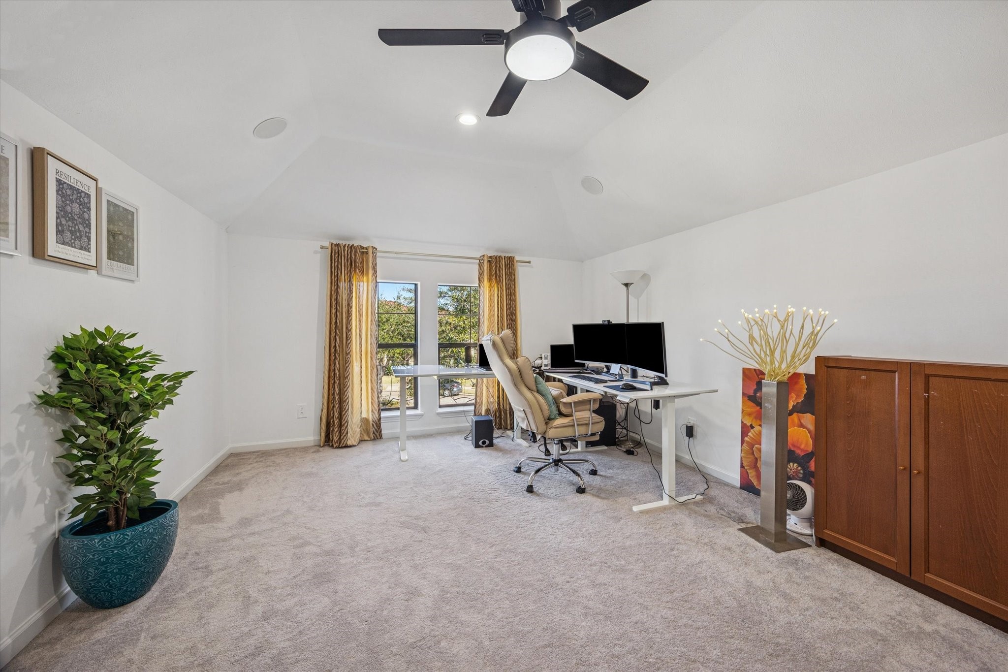 This spacious upstairs home office features a vaulted ceiling, ceiling fan, and large window for natural light. ideal for remote work or study. This is one of 2 flex spaces in the home.