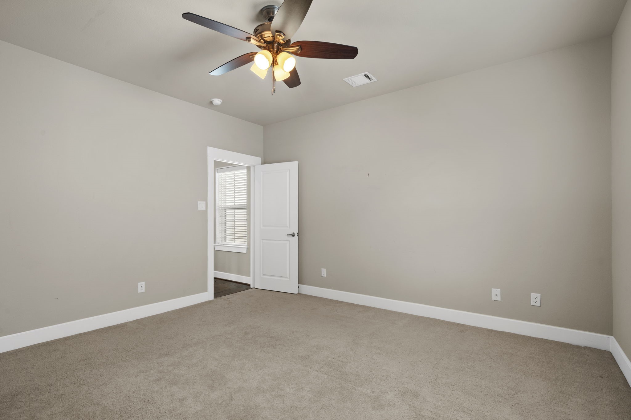 Alternate view of the third-floor secondary bedroom highlighting the comfortable living space.