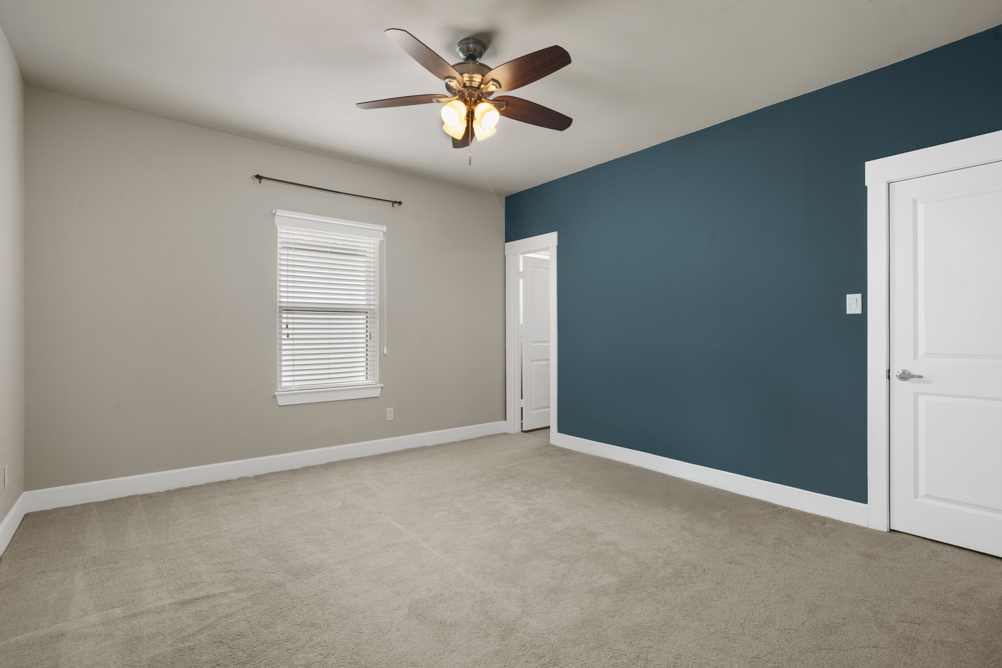 This third-floor secondary bedroom features a private en suite bathroom and a spacious walk-in closet.