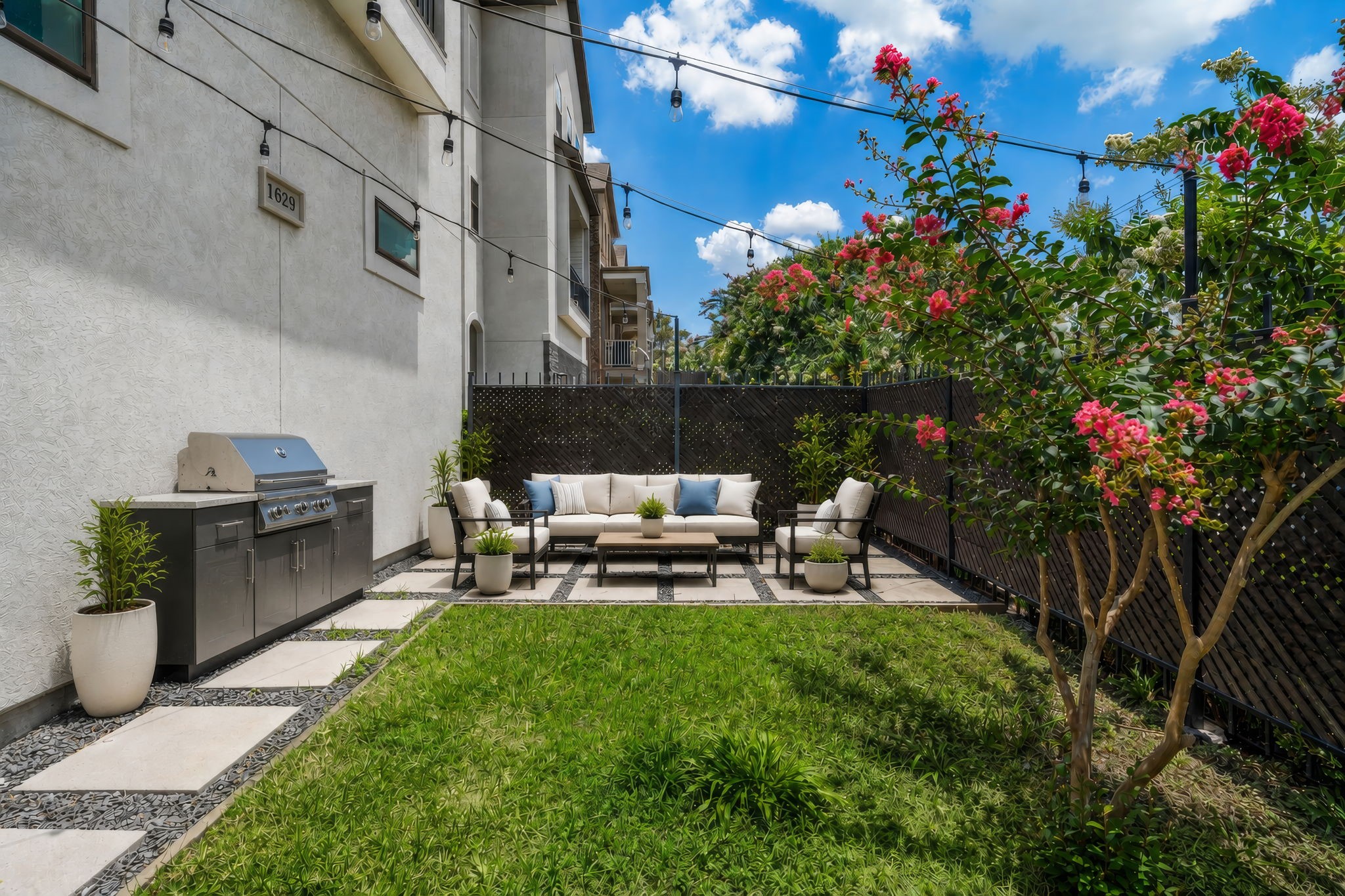 A private front courtyard offers a rare outdoor retreat in the heart of the cityan ideal space to enjoy morning coffee, unwind in the evening, or add container gardens and seasonal dcor. (Digitally staged.)