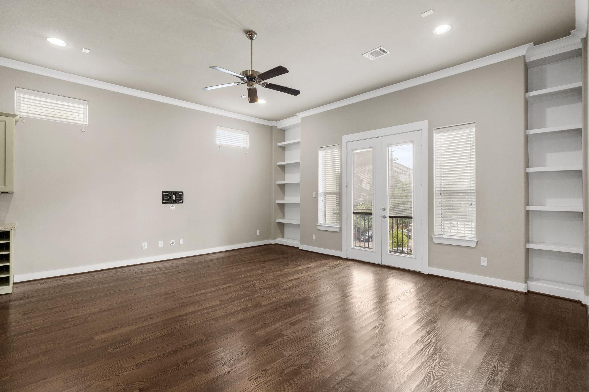 High clerestory windows fill the space with natural light while maintaining privacy, complemented by functional built-in shelving.