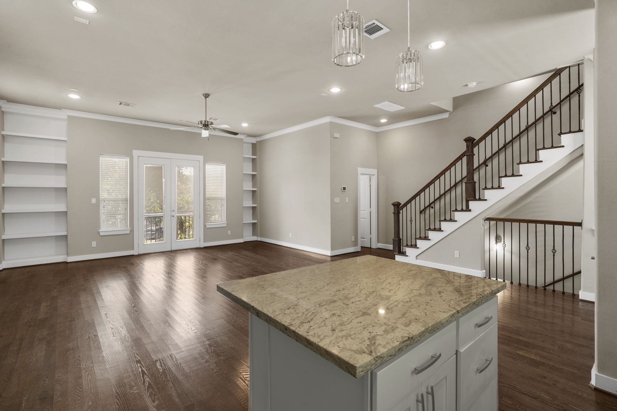 The second floor is designed for entertaining, featuring an open-concept living, dining and kitchen area, along with a convenient half bath.