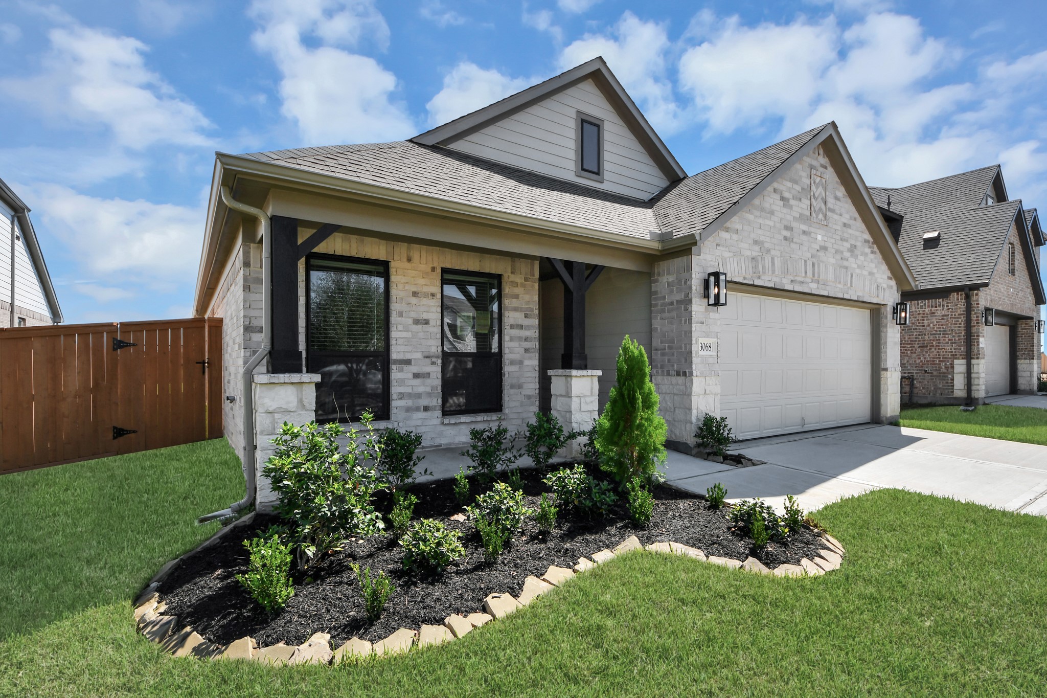 The residence features a practical 2-car garage complemented by a generous driveway, ensuring abundant space for parking needs.