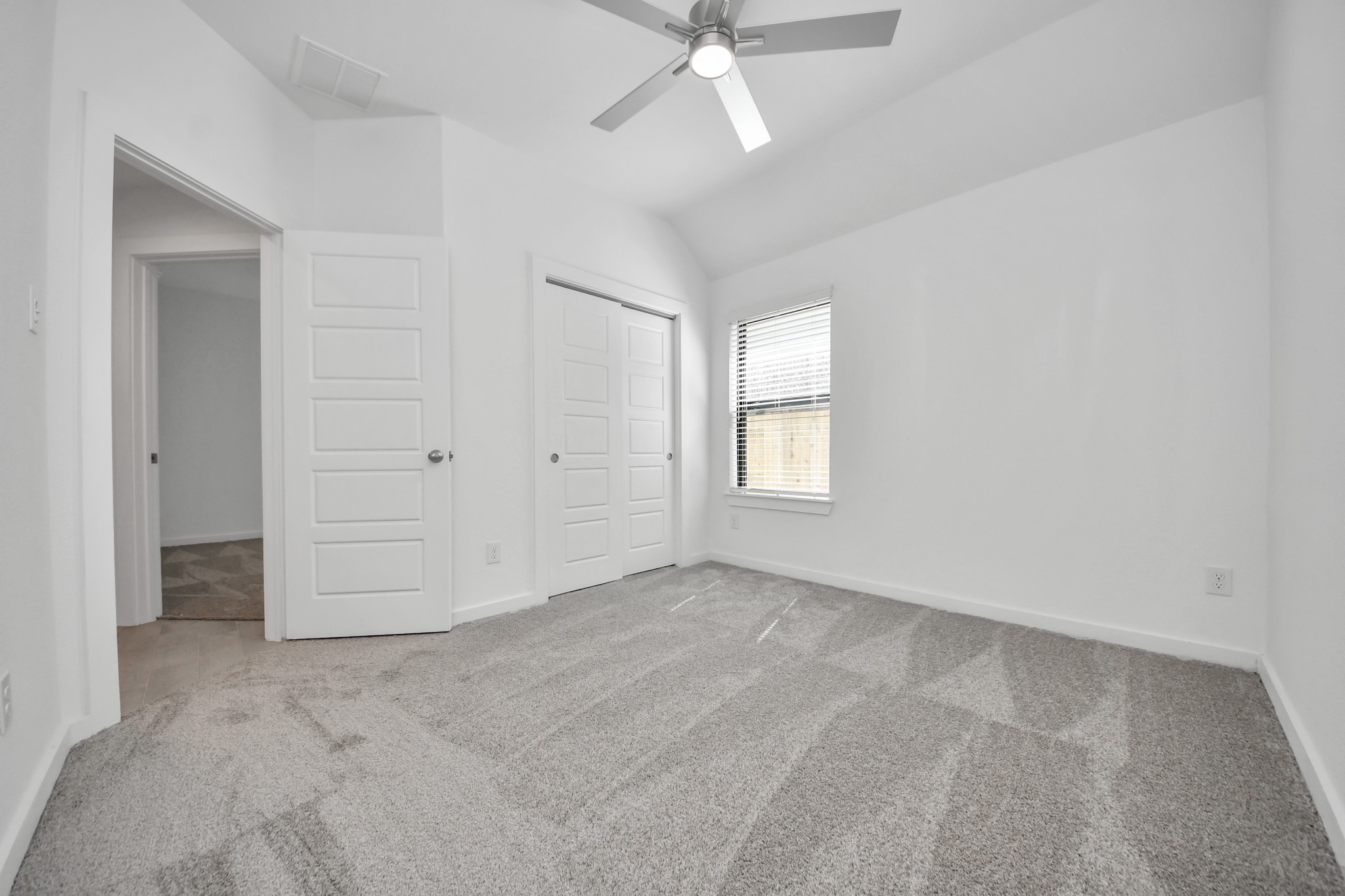 Generously sized secondary bedrooms featuring spacious closets, soft and inviting carpeting underfoot, large windows allowing plenty of natural light, and the added touch of privacy blinds for your personal retreat.