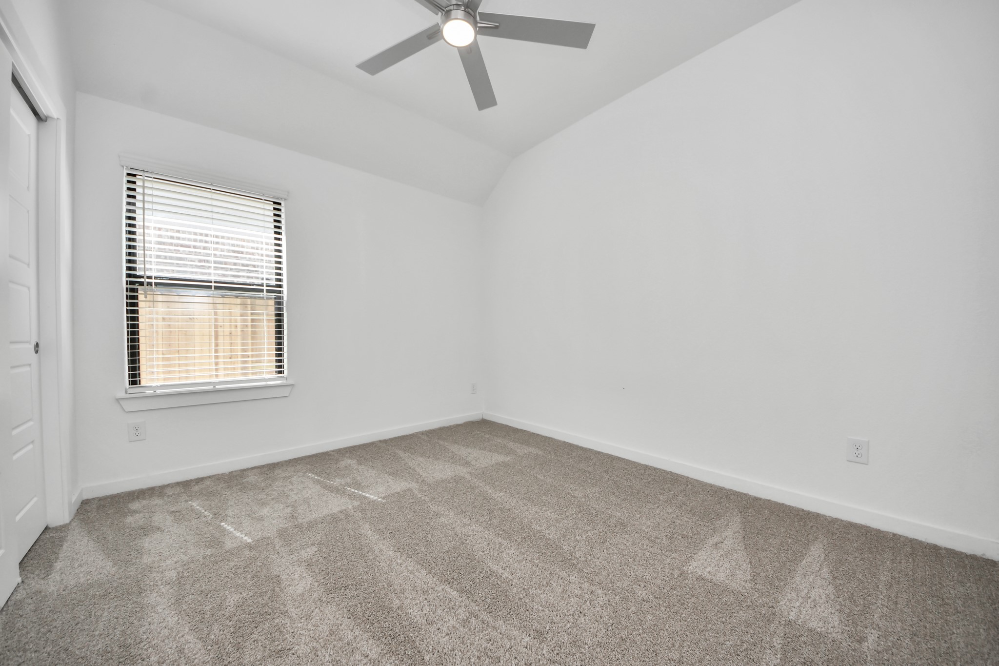 Secondary bedroom features plush carpeting, large windows that let in plenty of natural light, bright paint, and spacious closets.
