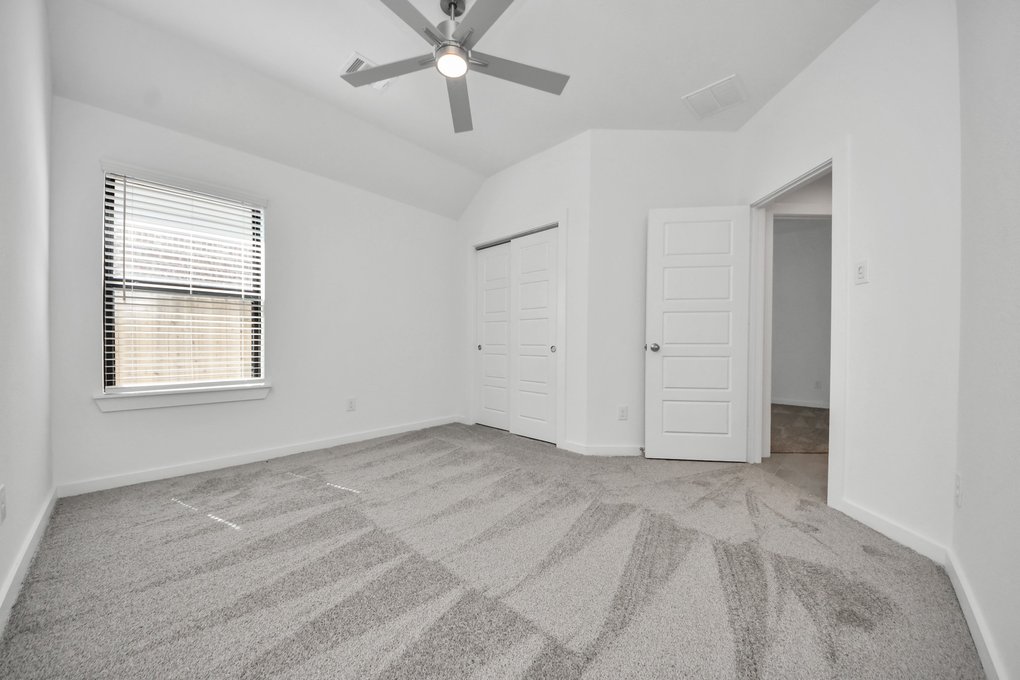 Generously sized secondary bedrooms featuring spacious closets, soft and inviting carpeting underfoot, large windows allowing plenty of natural light, and the added touch of privacy blinds for your personal retreat.